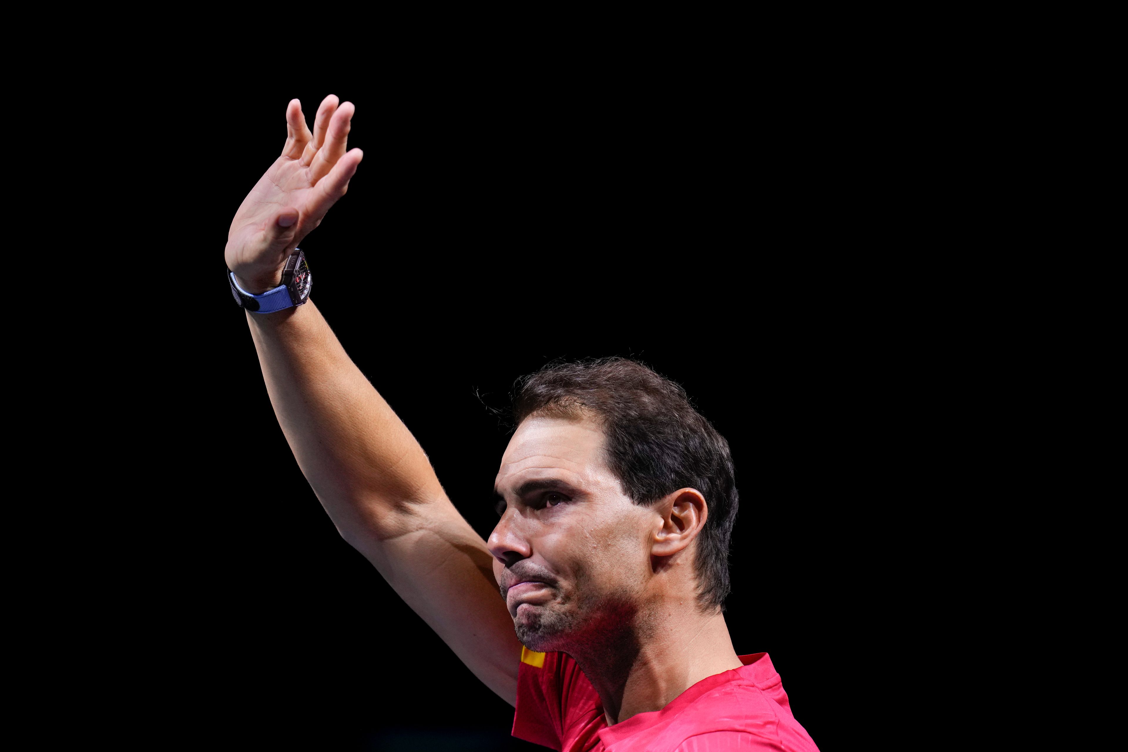 Spain's Rafael Nadal waves to the crowd during a tribute after playing his last match as a professional tennis player in the Davis Cup quarterfinals at the Martin Carpena Sports Hall in Malaga, southern Spain, early Wednesday, Nov. 20, 2024. (AP Photo/Manu Fernandez)