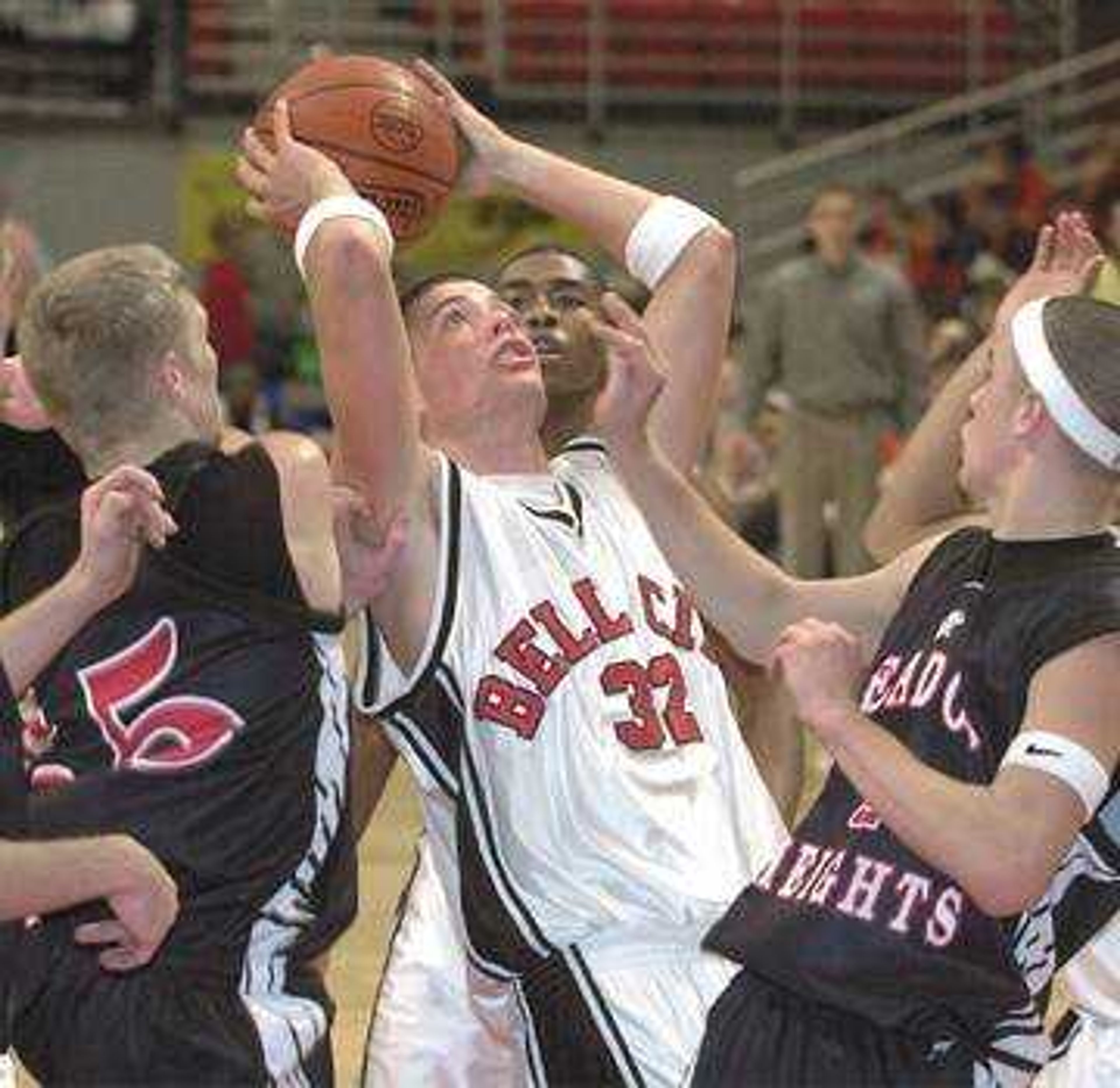 Bell City's Tyler Victor aimed for the goal between Meadow Heights' Brian Thompson, left, and Anthony Bollinger in the second quarter at the Show Me Center Friday.