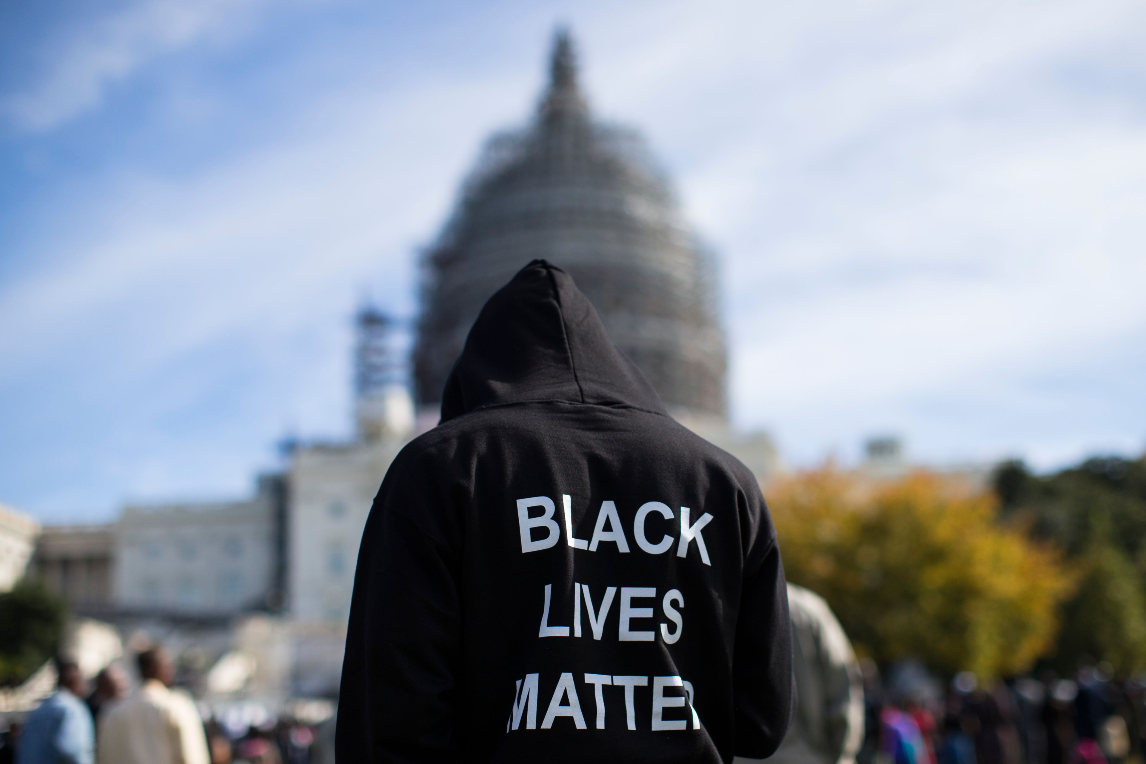 FILE - Neal Blair, of Augusta, Ga., wears a hoodie reading "Black Lives Matter" as he stands on the lawn of the Capitol building during a rally to mark the 20th anniversary of the Million Man March, on Capitol Hill, on Oct. 10, 2015, in Washington. (AP Photo/Evan Vucci, File)