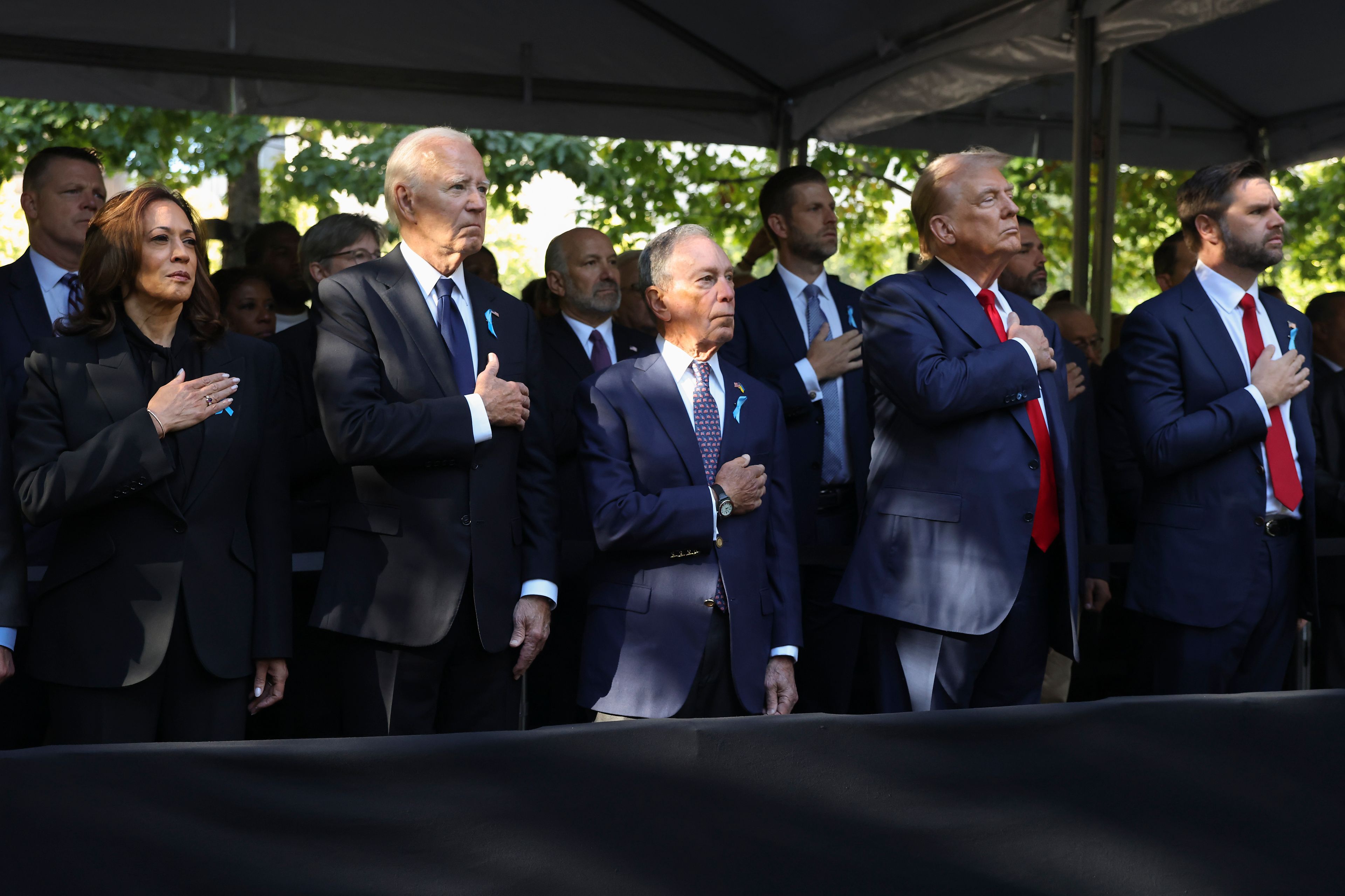 From left, Democratic presidential nominee Vice President Kamala Harris, President Joe Biden, Michael Bloomberg, Republican presidential nominee former President Donald Trump and Republican vice presidential nominee Sen. JD Vance, R-Ohio, attend the 9/11 Memorial ceremony on the 23rd anniversary of the Sept. 11, 2001 attacks, Wednesday, Sept. 11, 2024, in New York. (AP Photo/Yuki Iwamura)