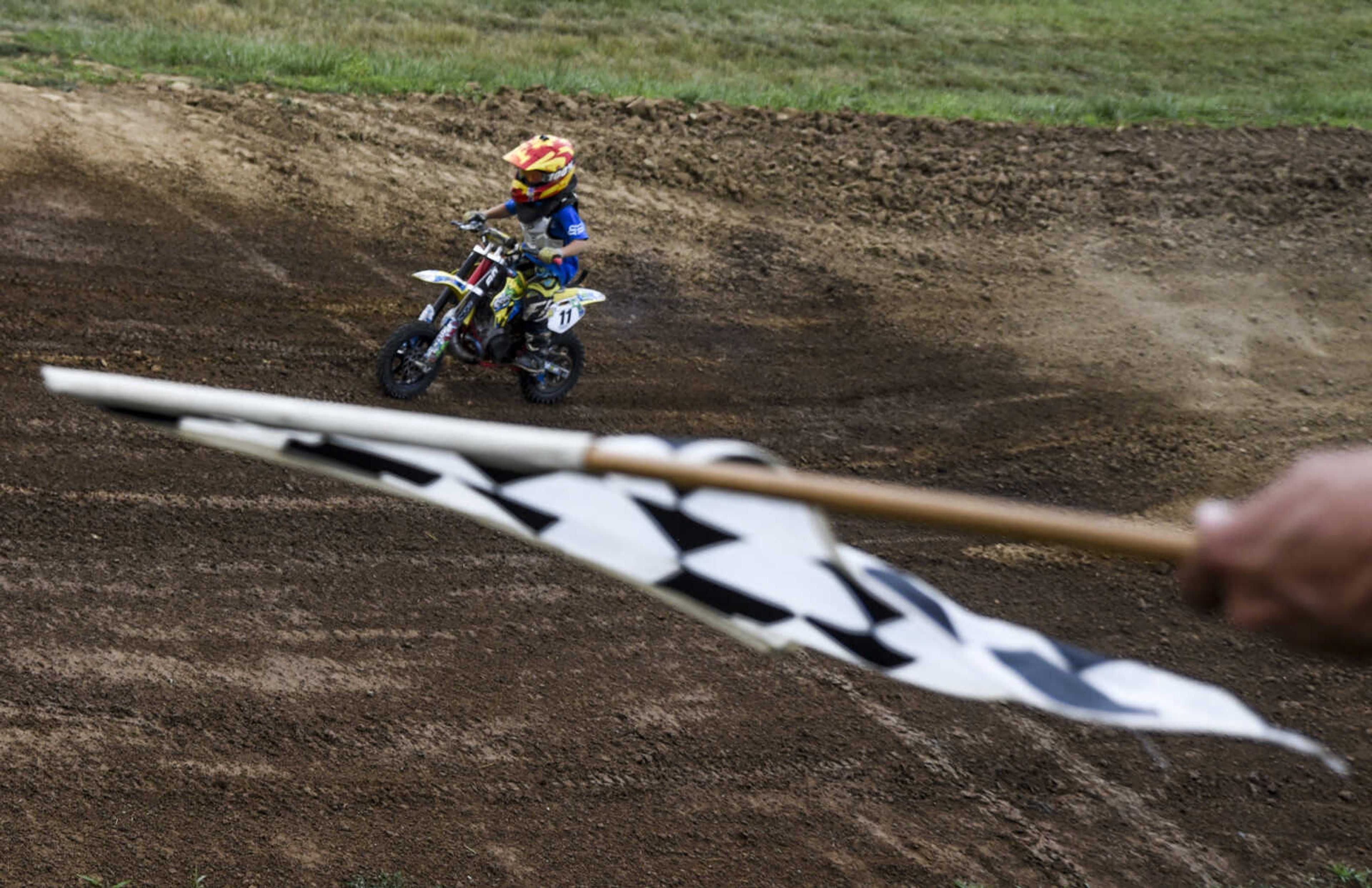 A "little bike" rider rides as he is flagged off the track for his final session lap during an open practice session at Sky High Motocross Park Wednesday, July 20, 2018 in Old Appleton.