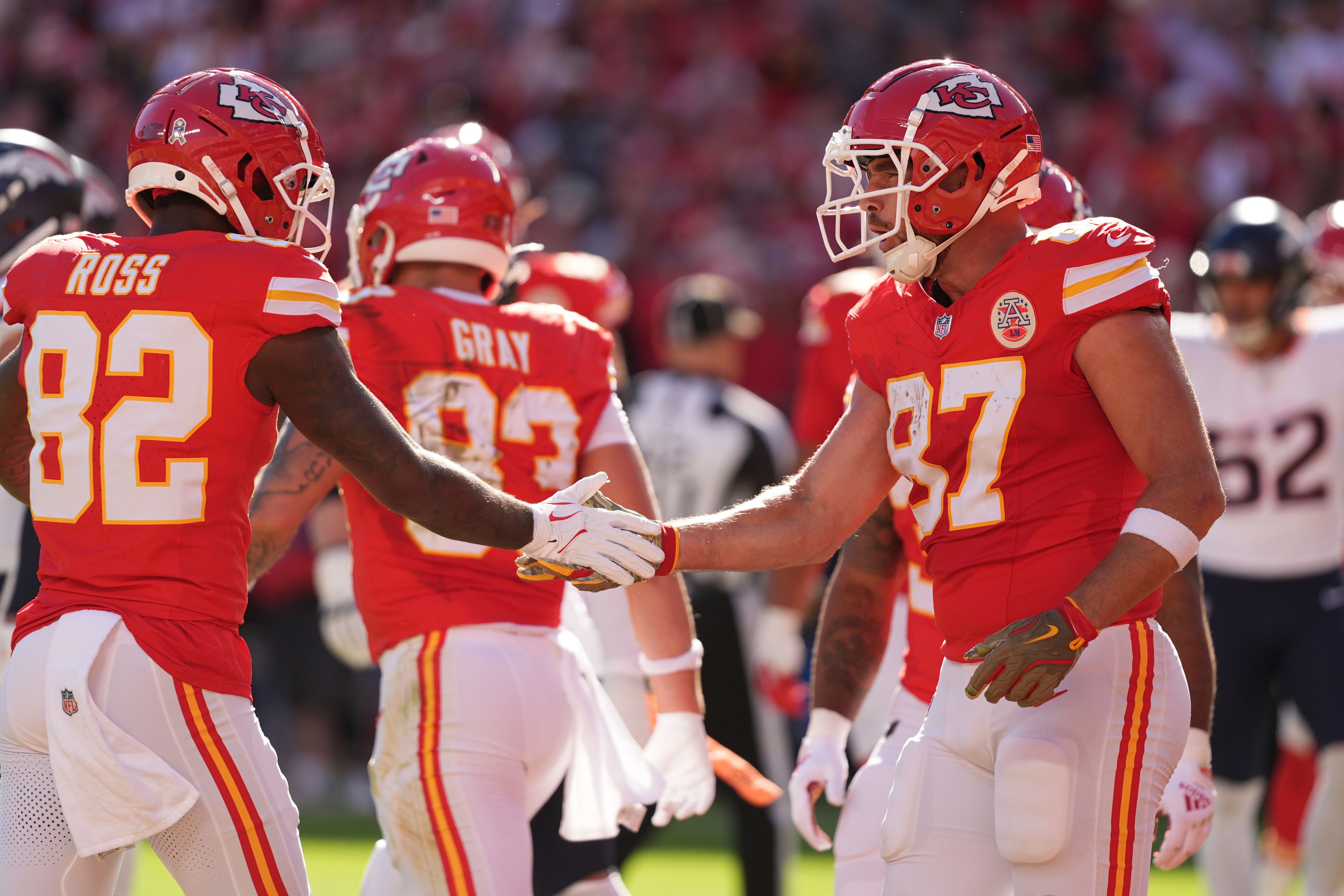 Kansas City Chiefs tight end Travis Kelce (87) is congratulated by Justyn Ross (82) after catching a touchdown pass during the first half of an NFL football game against the Denver Broncos Sunday, Nov. 10, 2024, in Kansas City, Mo. (AP Photo/Charlie Riedel)