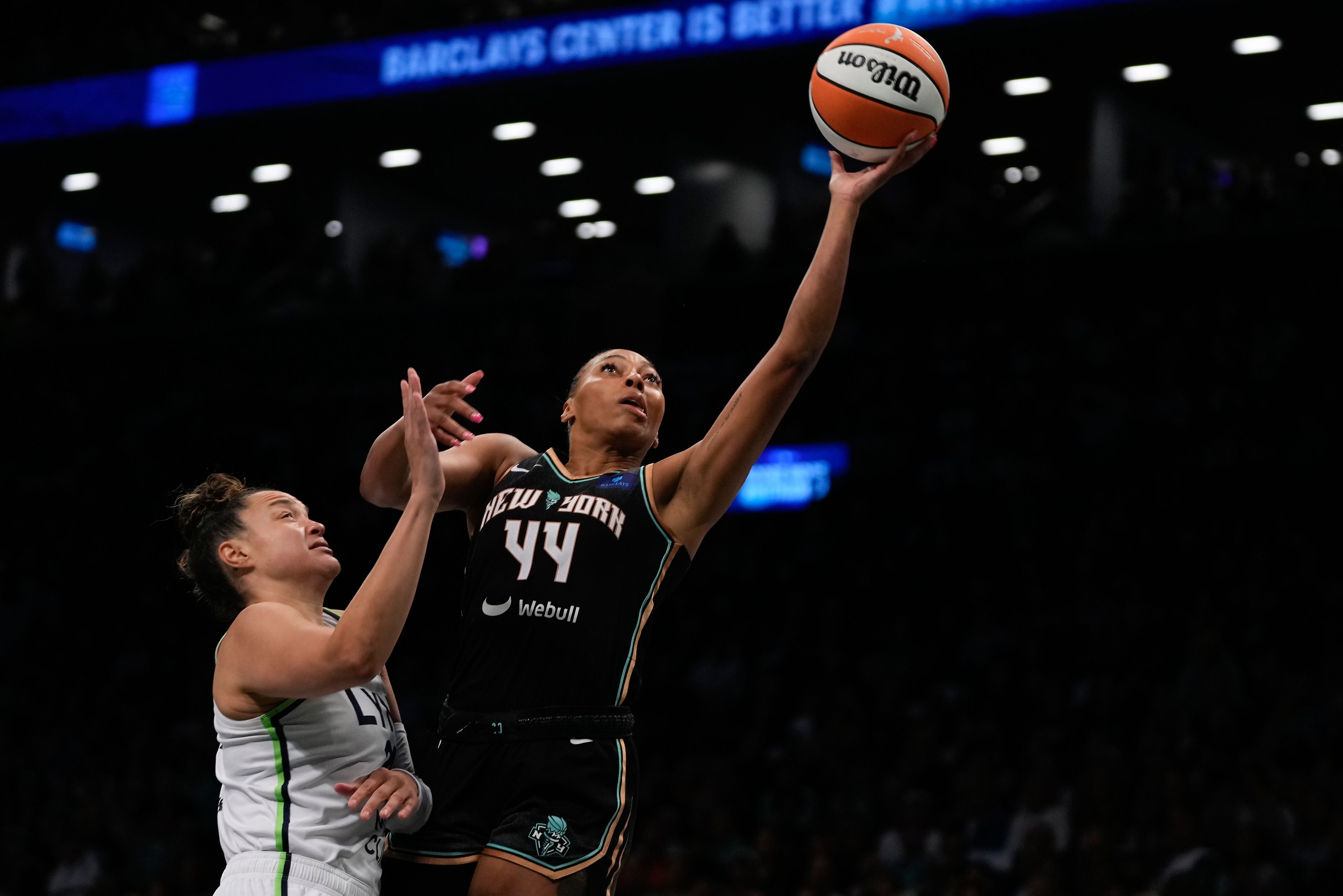 New York Liberty forward Betnijah Laney-Hamilton (44) puts up a shot against Minnesota Lynx guard Kayla McBride (21) during the first quarter of Game 5 of the WNBA basketball final series, Sunday, Oct. 20, 2024, in New York. (AP Photo/Pamela Smith)