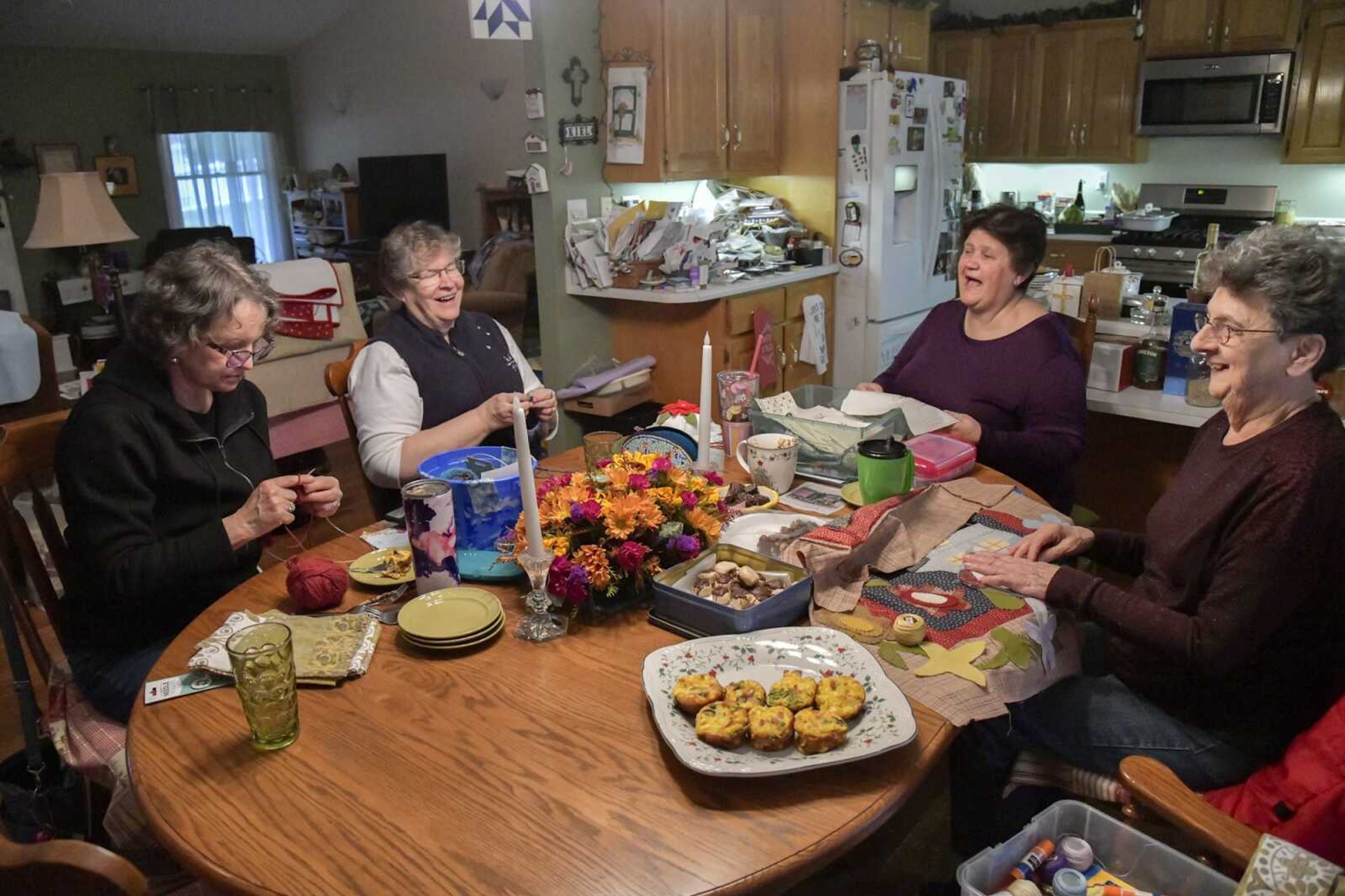 Members of the Jackson Scrapper Quilt Guild, from left, Linda Tansil, Beth Vegiard, Donna Kiel and Vivian Shea work on small crafts and share a laugh Wednesday at Kiel's home in Jackson.