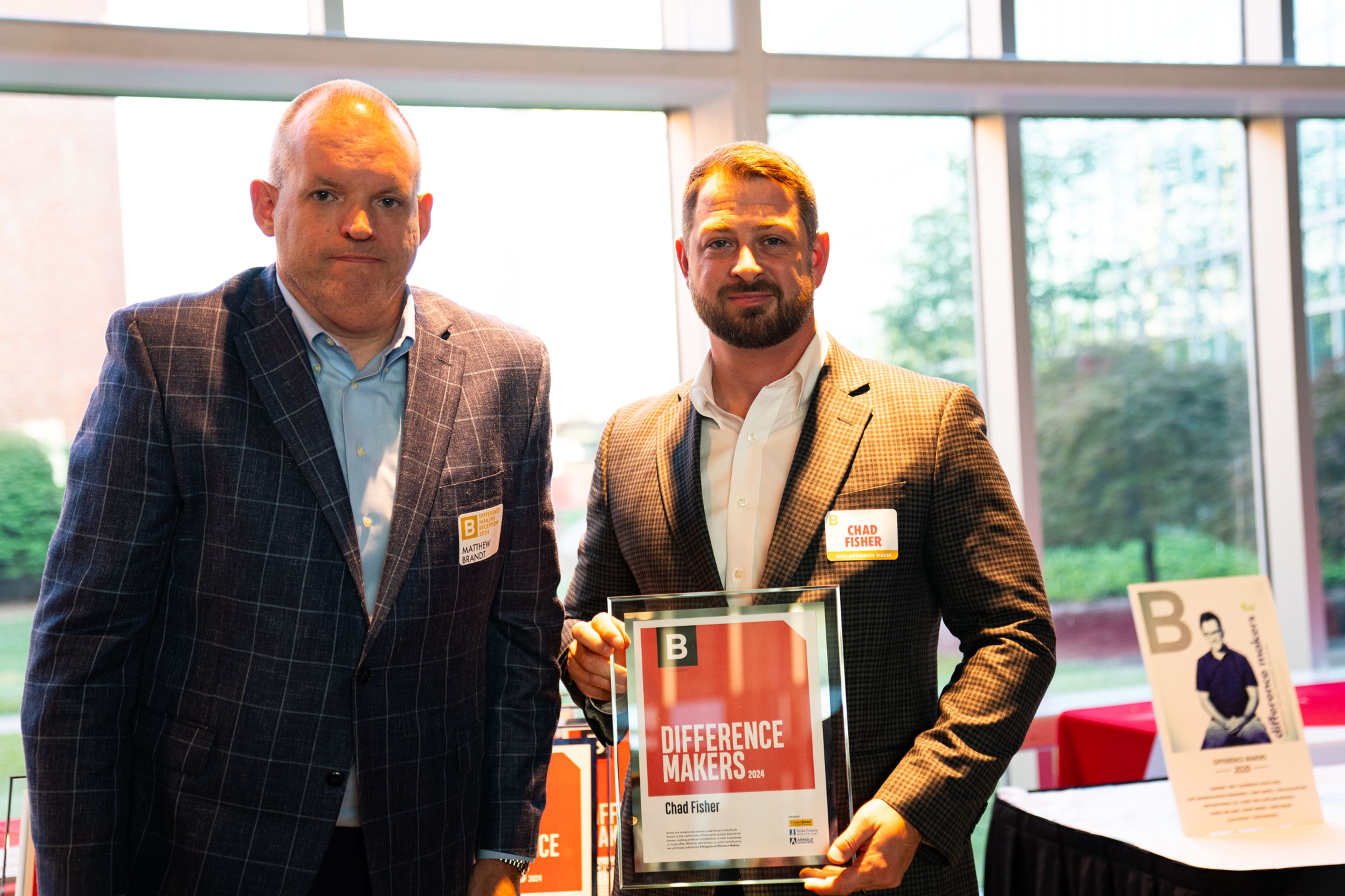 Chad Fisher receives a plaque from Saint Francis Healthcare System’s Matthew Brandt recognizing him as a 2024 Difference Maker at their reception at Southeast Missouri State University’s River Campus. The Difference Maker’s reception was presented by B Magazine on Thursday, Sept. 6.