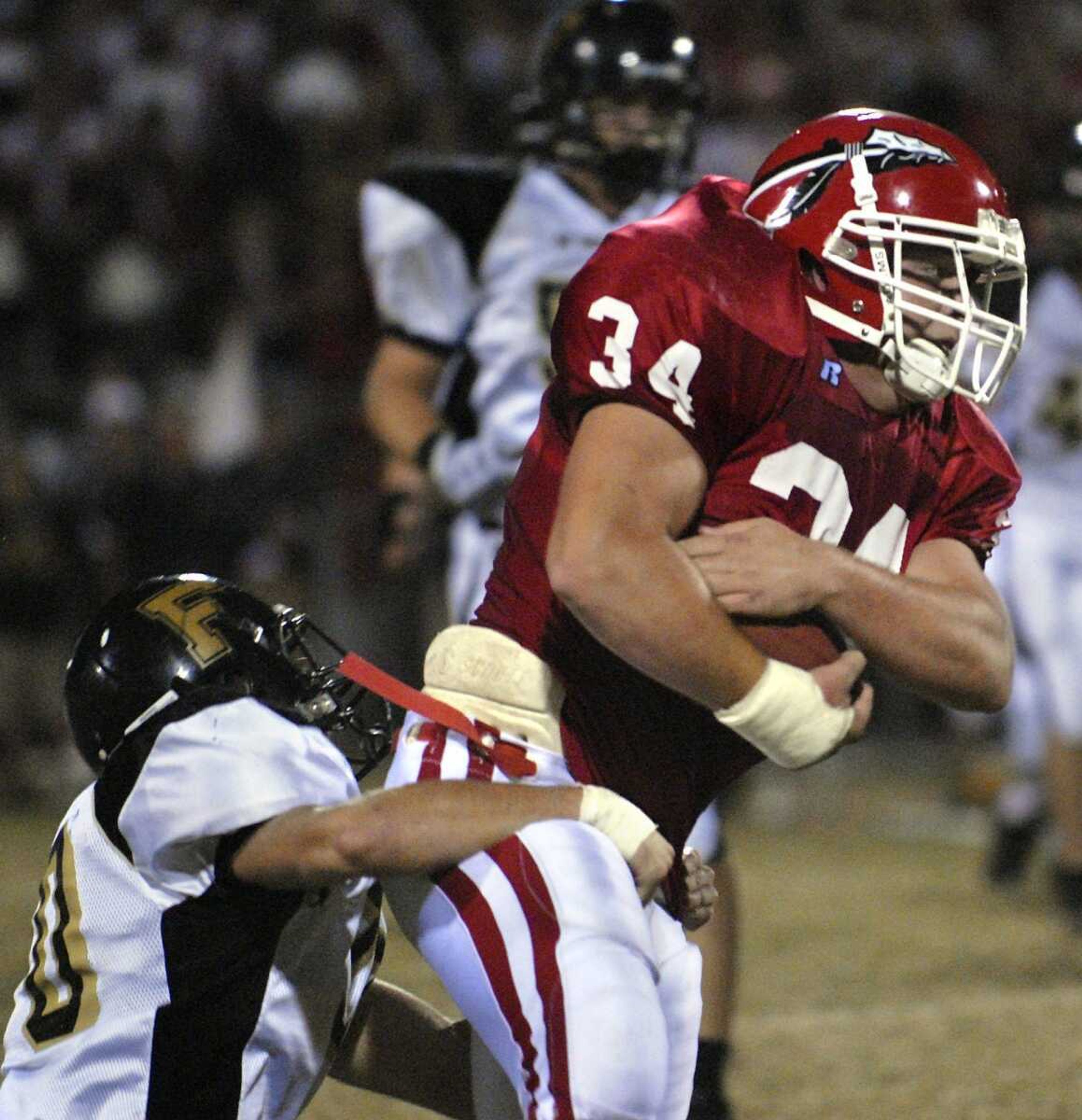 ELIZABETH DODD ~ edodd@semissourian.com
Jackson's Andy Winkleblack is brought down by Farmington's Andrew Huhman after making a 19-yard reception during the first half Friday at Jackson.