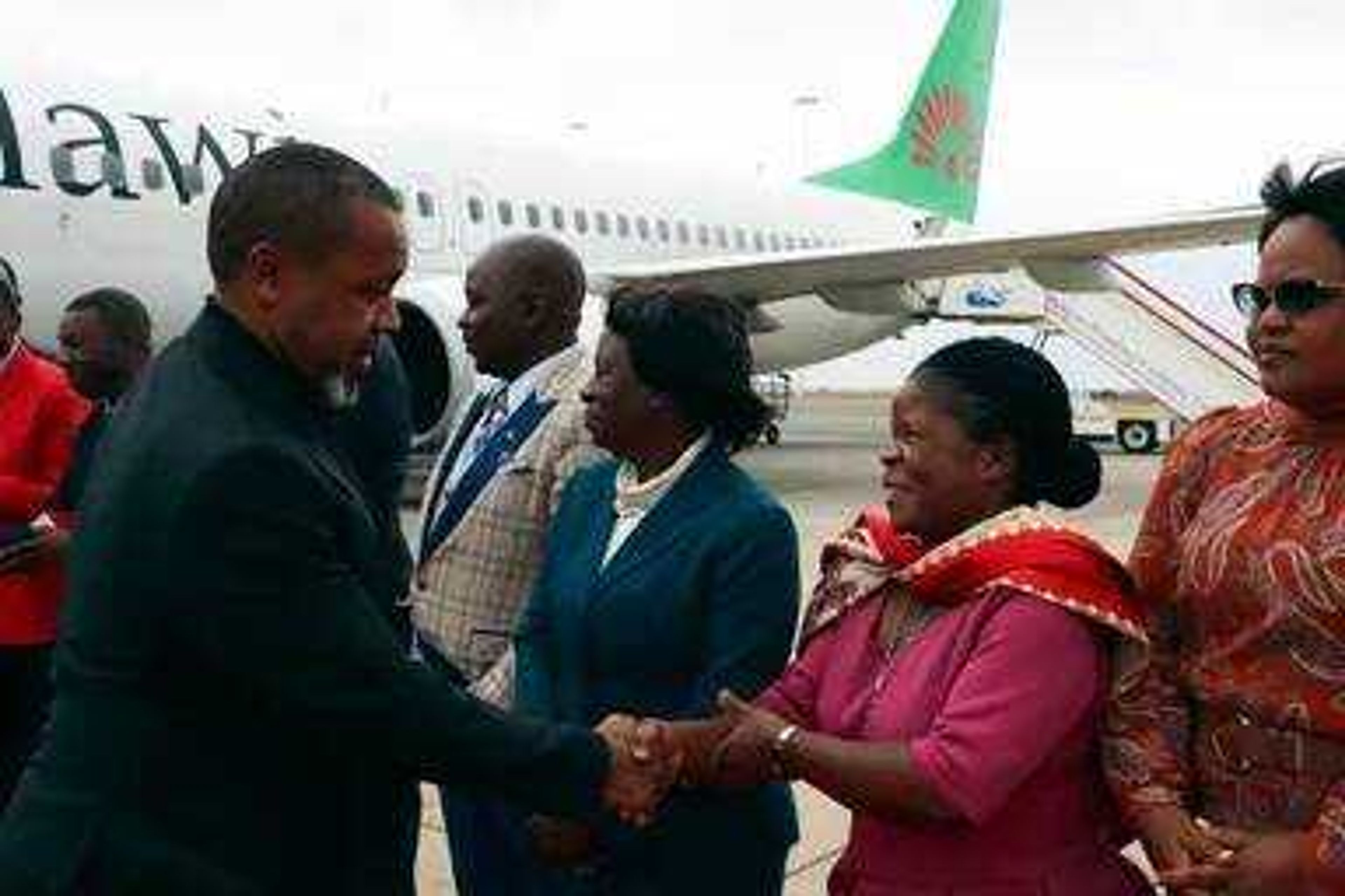 Malawi Vice President Saulos Chilima, left, greets government officials upon his return from South Korea in Lillongwe, Sunday, June 9, 2024. A military plane carrying Malawi's vice president and nine others went missing Monday and a search was underway, the president's office said. The plane carrying 51-year-old Vice President Saulos Chilima left the capital, Lilongwe, but failed to make its scheduled landing at Mzuzu International Airport about 370 kilometers (230 miles) to the north around 45 minutes later. 