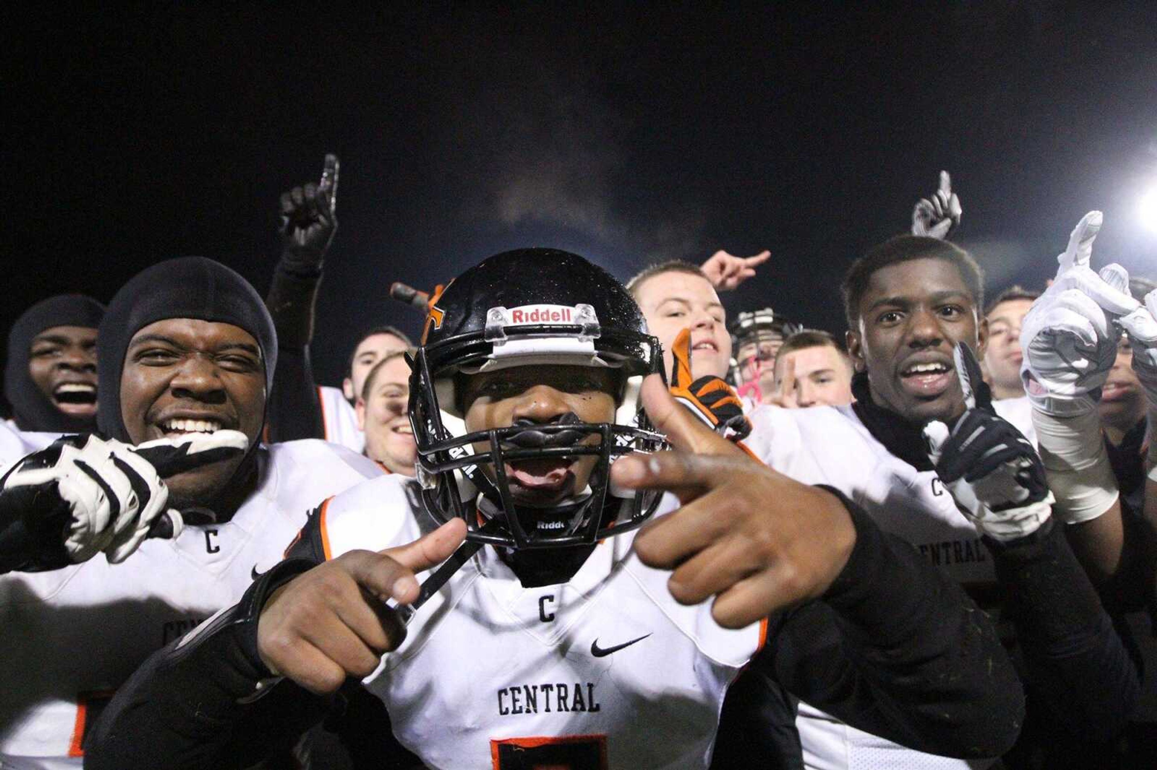 Central's Nikylus Thompson, center, and his teammates celebrate after the Tigers defeated St. Charles West 42-21 in a Class 4 semifinal Friday in St. Charles, Missouri. (Glenn Landberg)