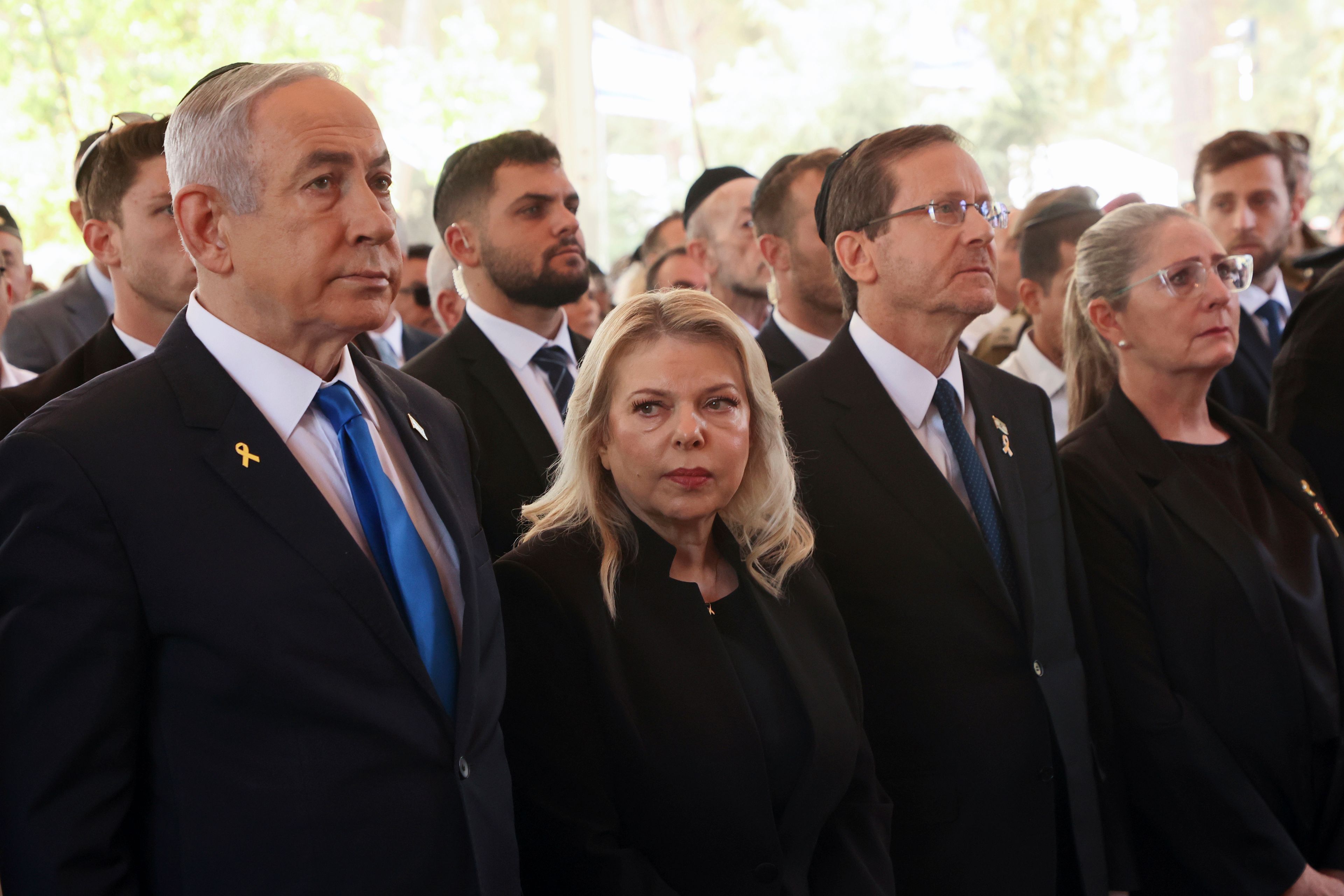 Israel's Prime Minister Benjamin Netanyahu, from left, his wife Sara Netanyahu, President Isaac Herzog and First Lady Michal Herzog, attend a ceremony marking the Hebrew calendar anniversary of the Hamas attack on October 7 last year, at the Mount Herzl military cemetery in Jerusalem, Israel Sunday Oct. 27, 2024. (Gil Cohen-Magen/Pool Photo via AP)