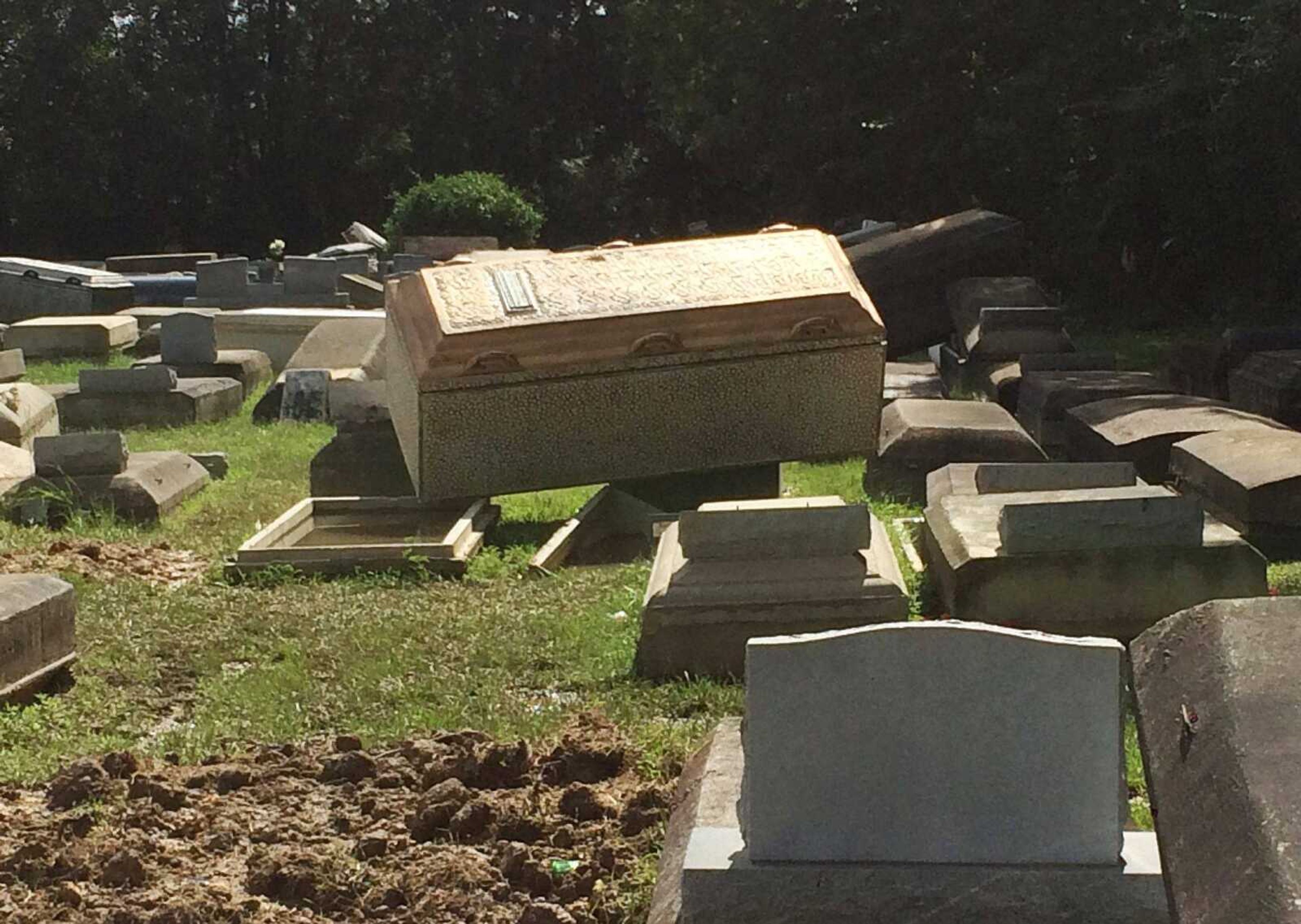 Coffins lie unearthed Thursday in Plainview Cemetery in Denham Springs, Louisiana.