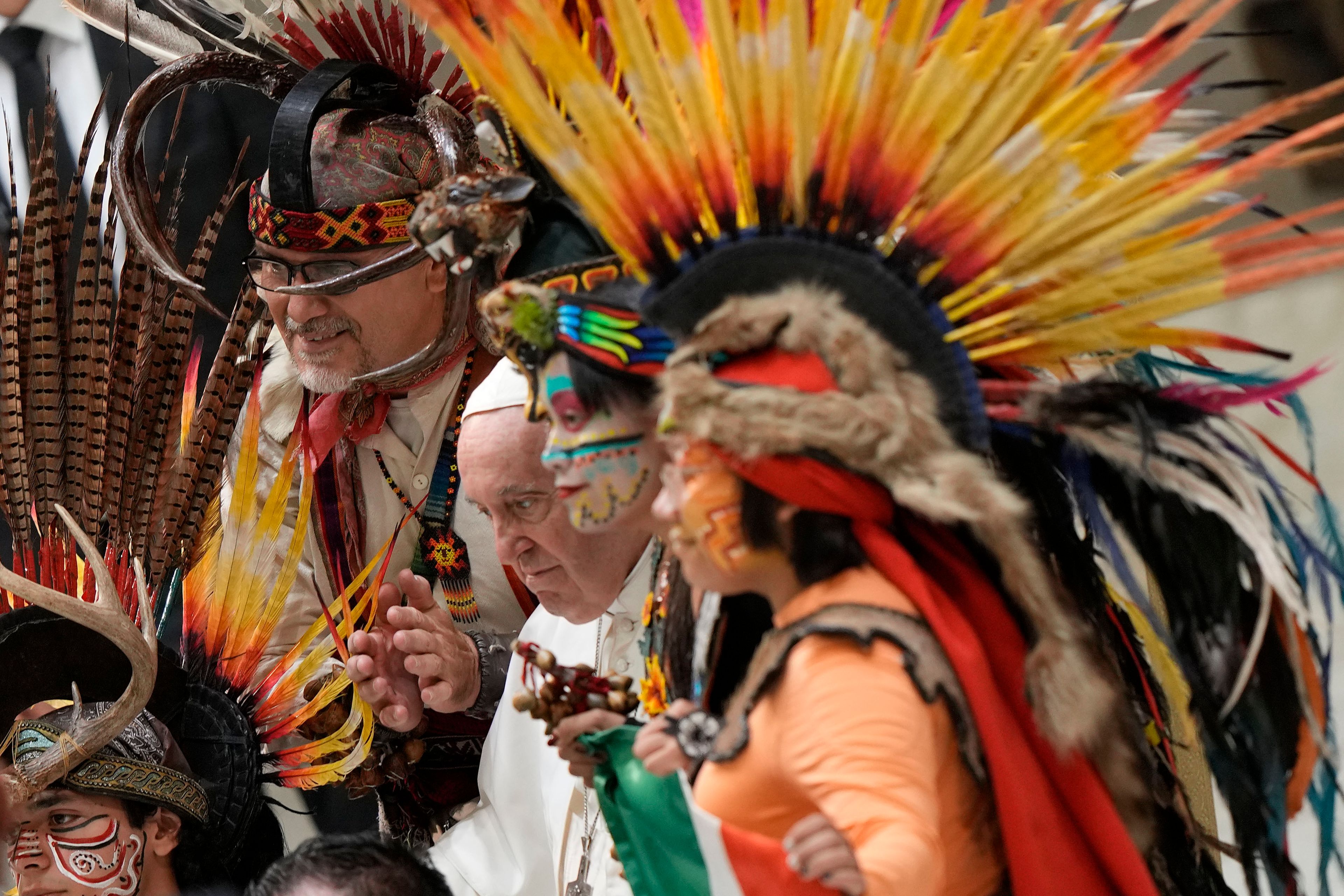 FILE - Pope Francis poses for a family picture with a group of Mexican pilgrims wearing traditional clothes during the weekly general audience at the Vatican, Aug. 10, 2022. (AP Photo/Andrew Medichini, File)