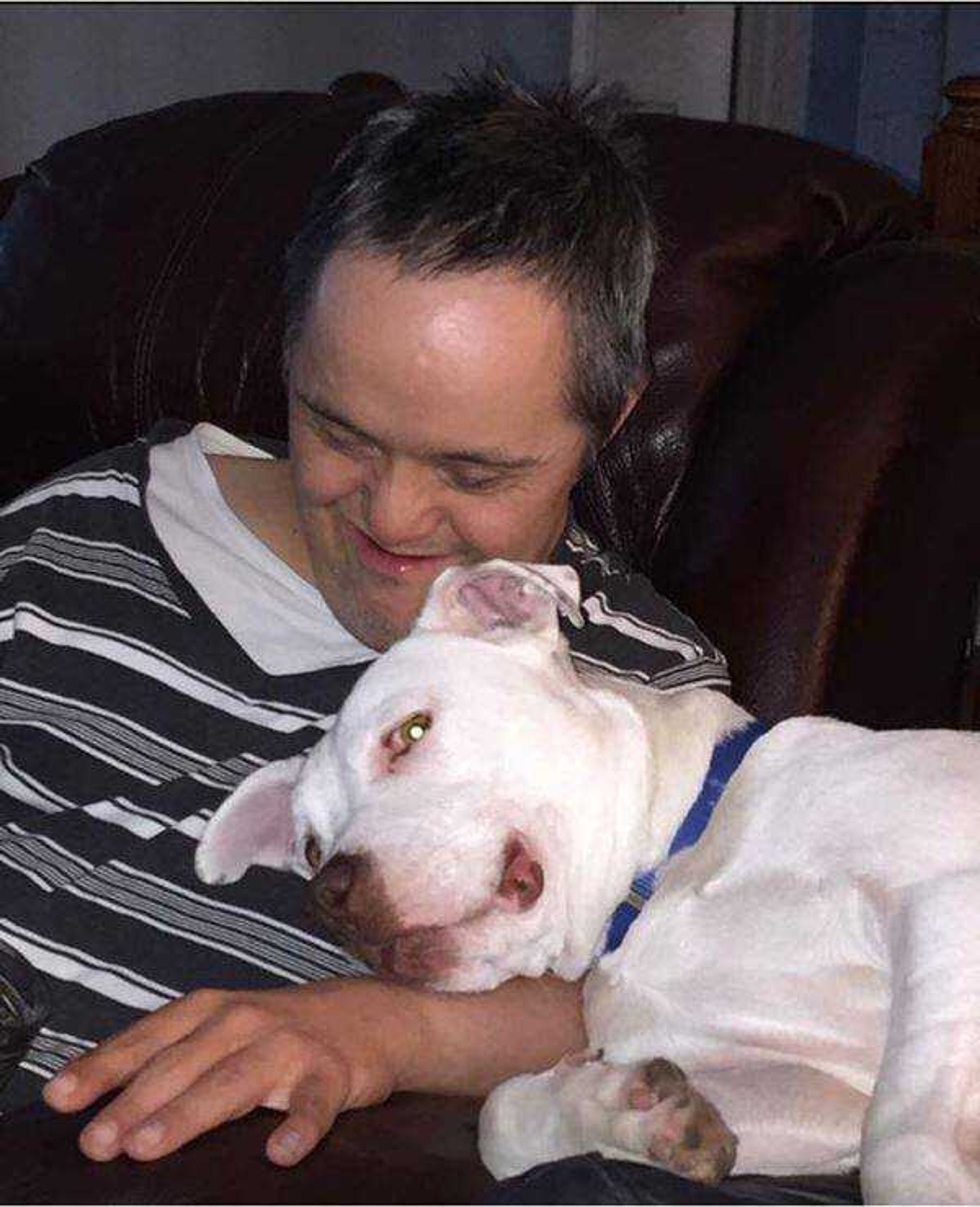 Buddy Loves Everyone! -&nbsp;Buddy was rescued from the streets of Memphis. He spends his days as an office dog happily greeting everyone he meets. Here he is loving on my brother.