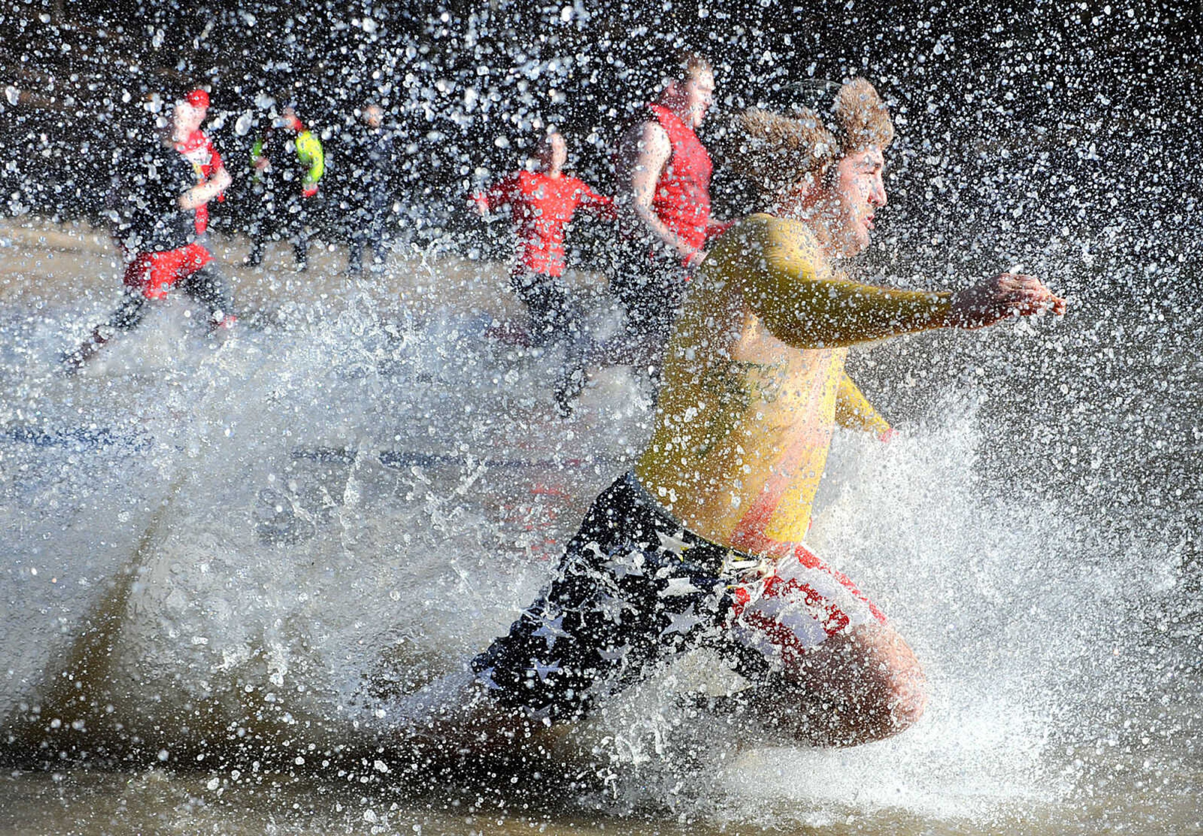 LAURA SIMON ~ lsimon@semissourian.com
People plunge into the cold waters of Lake Boutin Saturday afternoon, Feb. 2, 2013 during the Polar Plunge at Trail of Tears State Park. The lake's water temperature Saturday was 28 degrees. Thirty-six teams totaling 291 people took the annual plunge that benefits Special Olympics. Each team has to raise a minimum of 75 dollars to participate.