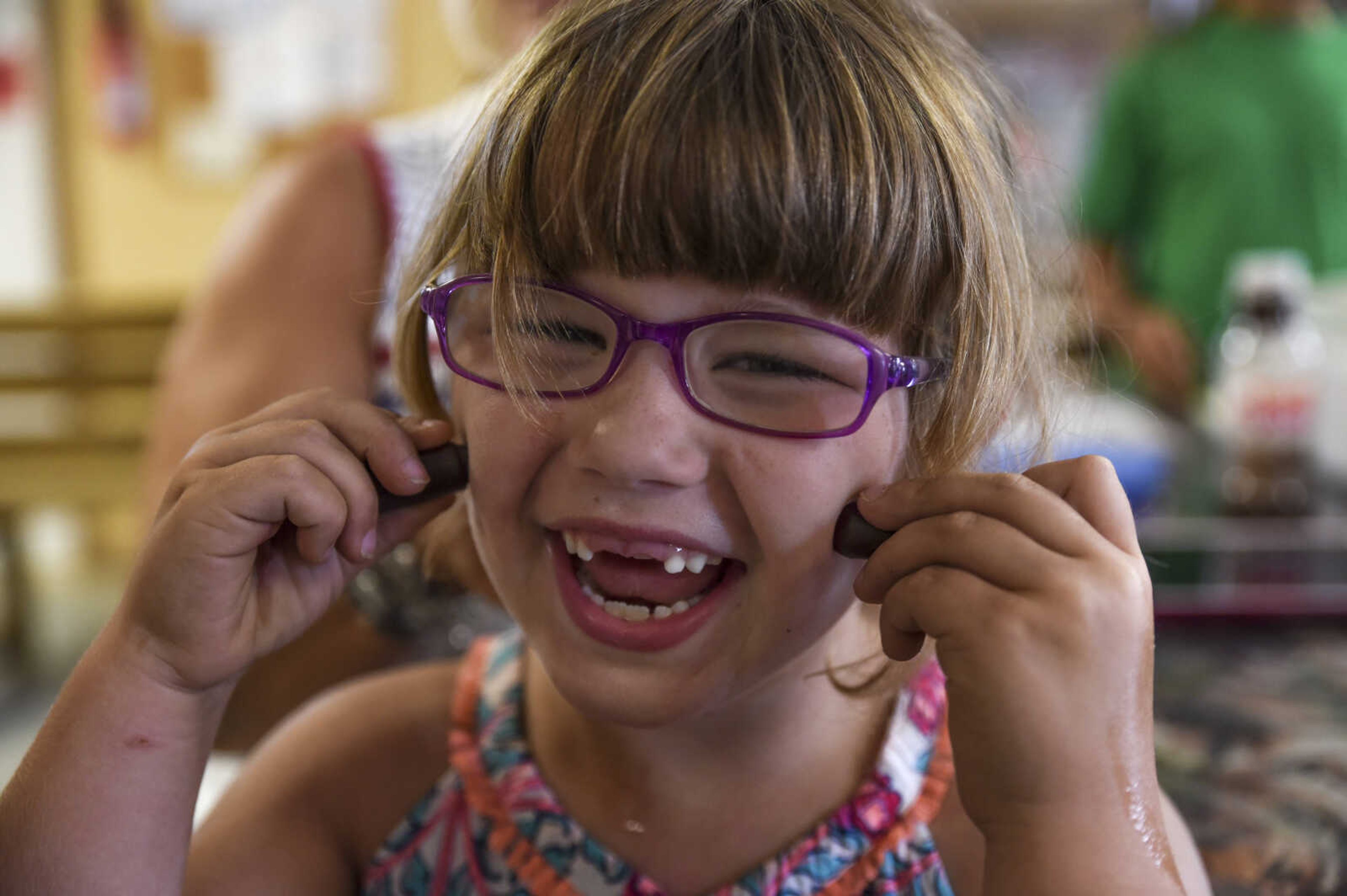 Lindyn Davenport, 6, smiles for a photo during a summer camp session at Mississippi Valley Therapeutic Horsemanship Friday, June 8, 2018 in Oak Ridge.