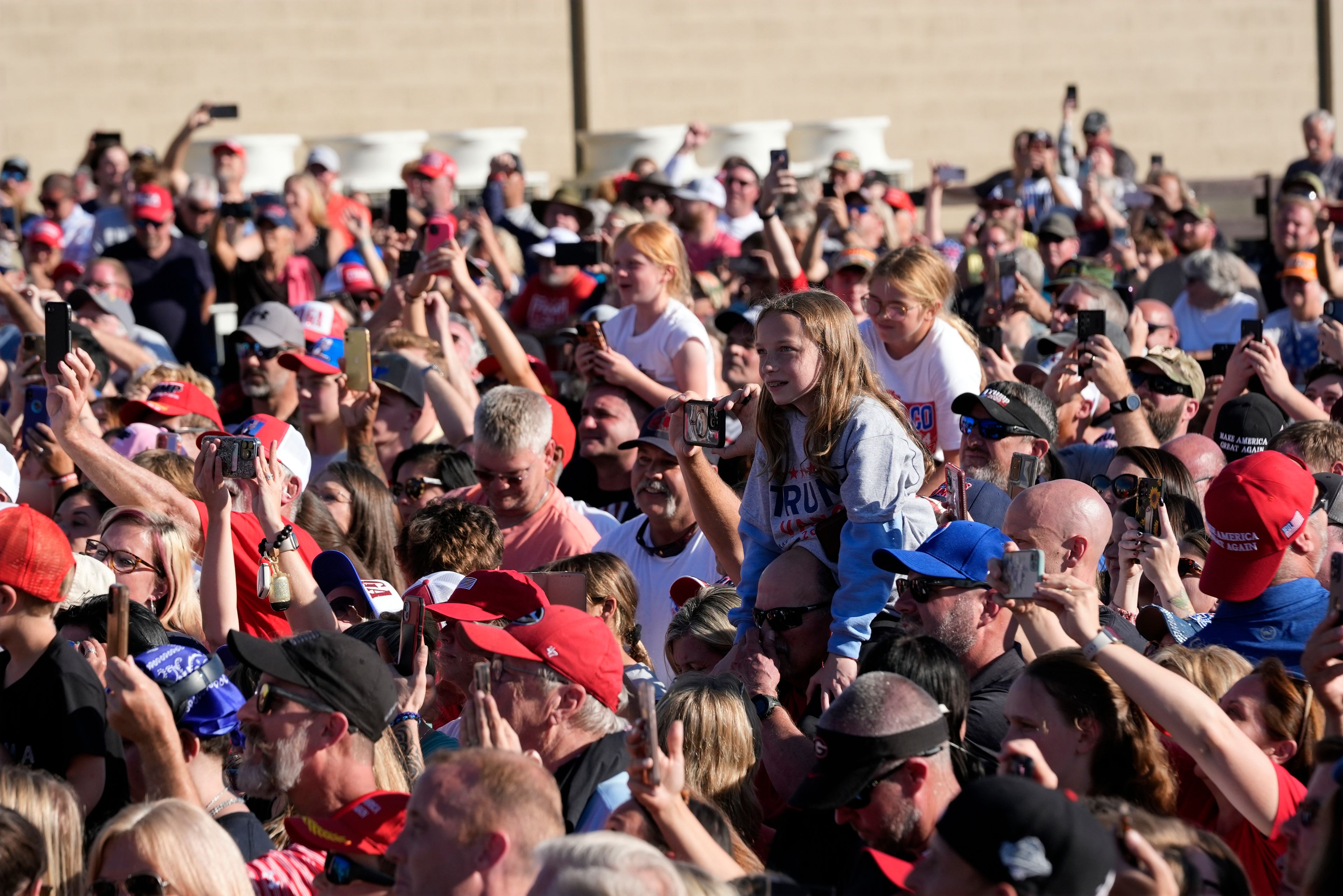 People listen as Republican presidential nominee former President Donald Trump speaks to an overflow crowd after a faith town hall at Christ Chapel Zebulon, Wednesday, Oct. 23, 2024, in Zebulon, Ga. (AP Photo/Alex Brandon)