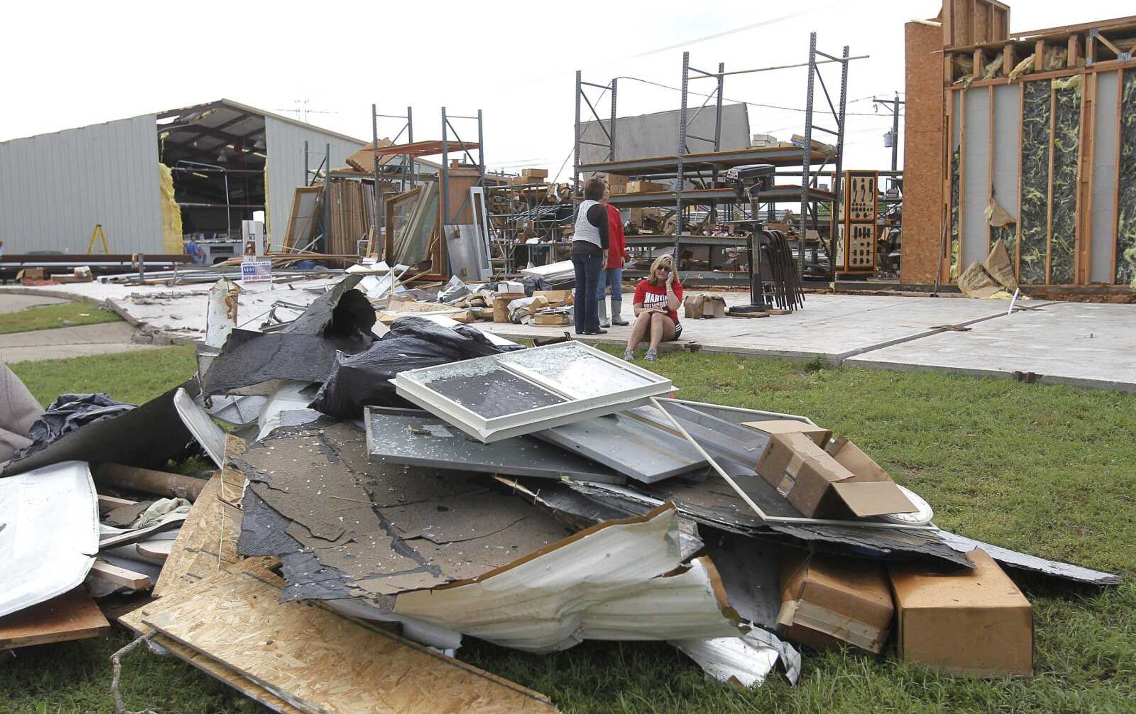 Co-owner Dawn Henderson sits down Wednesday on the slab of her business M&amp;M Door/Window in Kennedale, Texas. Storms and tornadoes swept through the area Tuesday. Preliminary findings indicate one of the tornadoes that struck North Texas had wind gusts ranging from 136 to 165 mph. As many as a dozen twisters touched down across Dallas-Fort Worth. Thousands remained without power Wednesday and hundreds of homes were severely damaged. Officials reported more than 20 injuries, but no deaths. (Rodger Mallison ~ Star-Telegram)