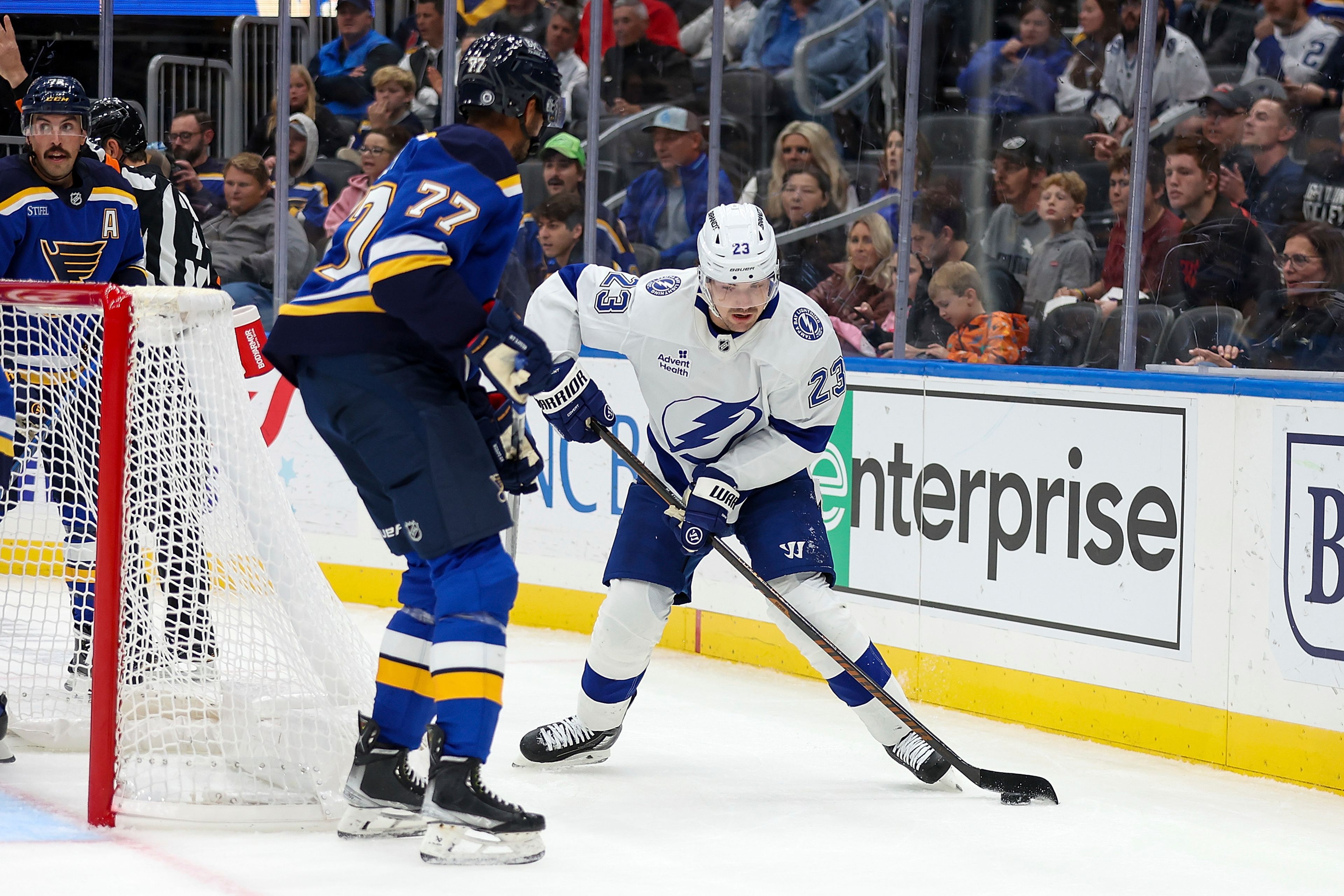 Tampa Bay Lightning's Michael Eyssimont (23) controls the puck as St. Louis Blues' Pierre-Olivier Joseph (77) defends during the first period of an NHL hockey game Tuesday, Nov. 5, 2024, in St. Louis. (AP Photo/Scott Kane)