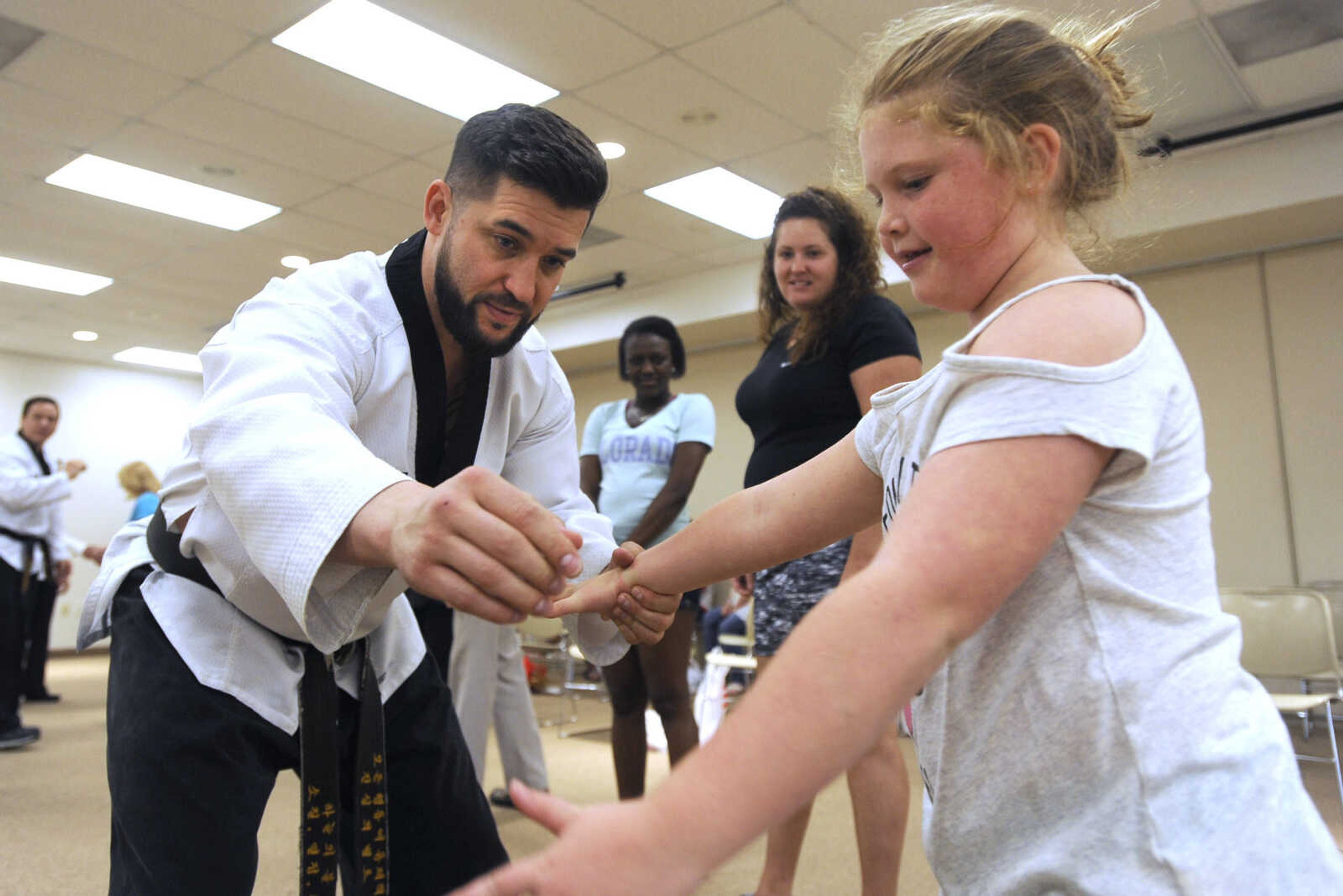 FRED LYNCH ~ flynch@semissourian.com
DeRay Ivie shows Bella Williams, 7, a Taekwondo technique Thursday, May 10, 2018 at the Flourish Ladies Night Out at the Osage Centre. More photos are in a gallery at semissourian.com.