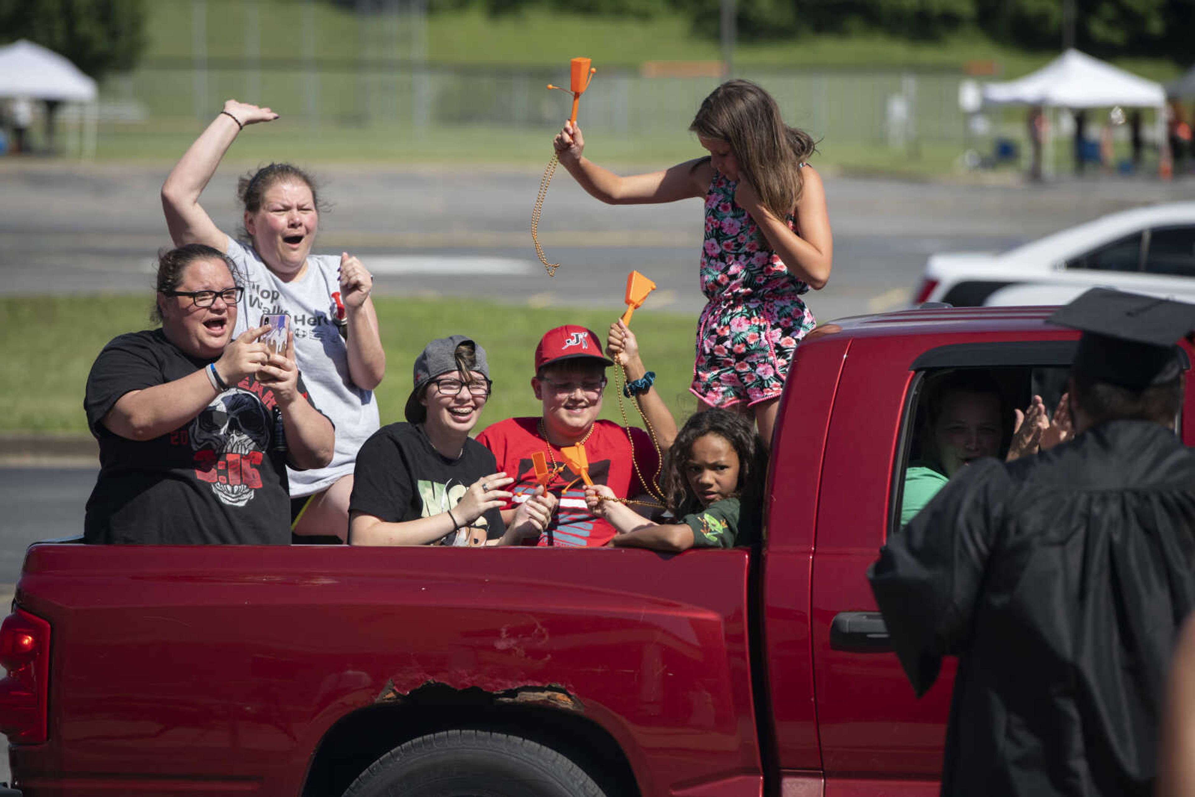 Supporters cheer for a graduate during a drive-through graduation ceremony Saturday, June 13, 2020, at Cape Girardeau Central High School in Cape Girardeau.&nbsp;