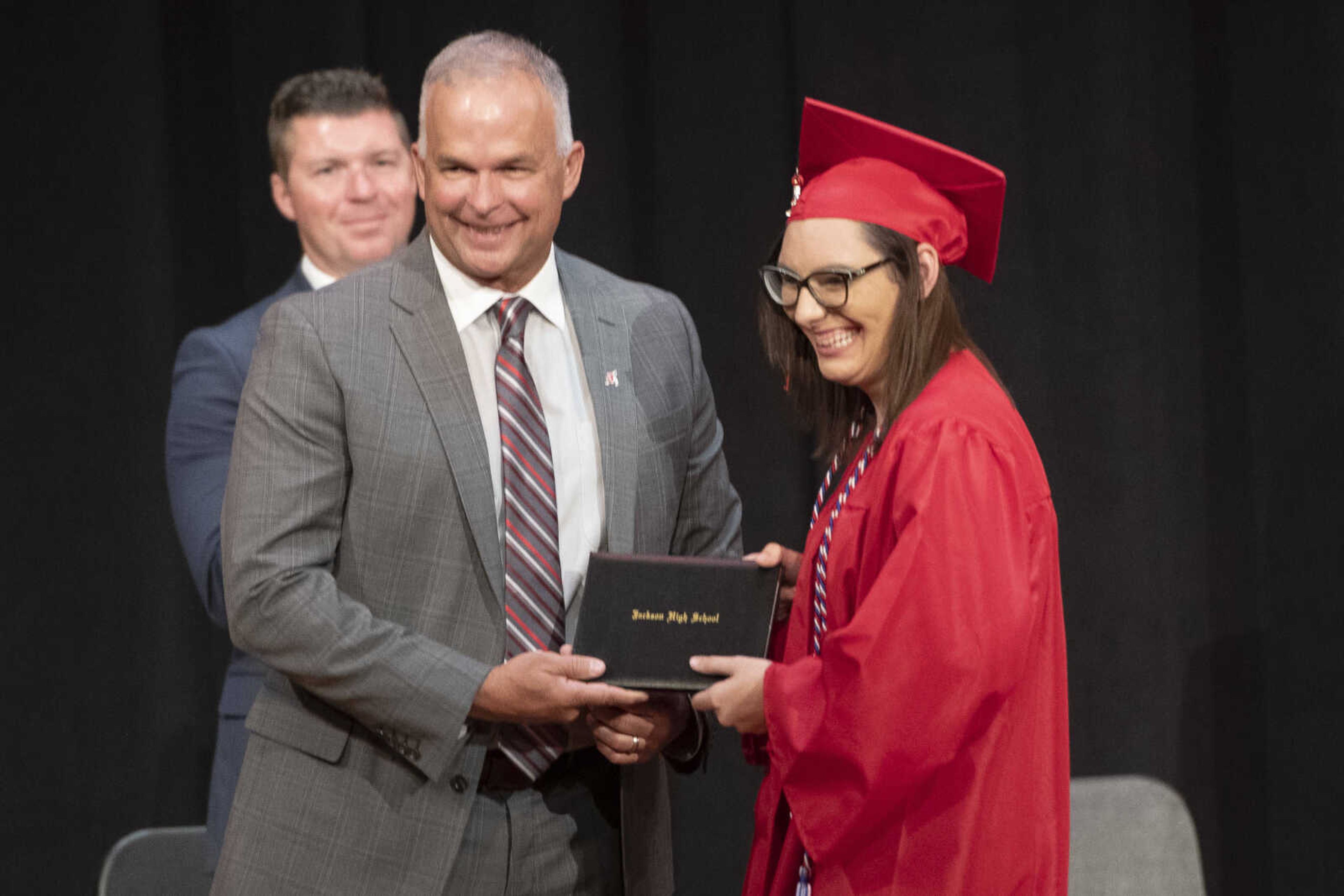 Jackson High School graduate Amber Marie Lowes has a picture made Kelly Waller, president of the board of education, during an in-person military graduation ceremony Friday, May 22, 2020, at Jackson High School.