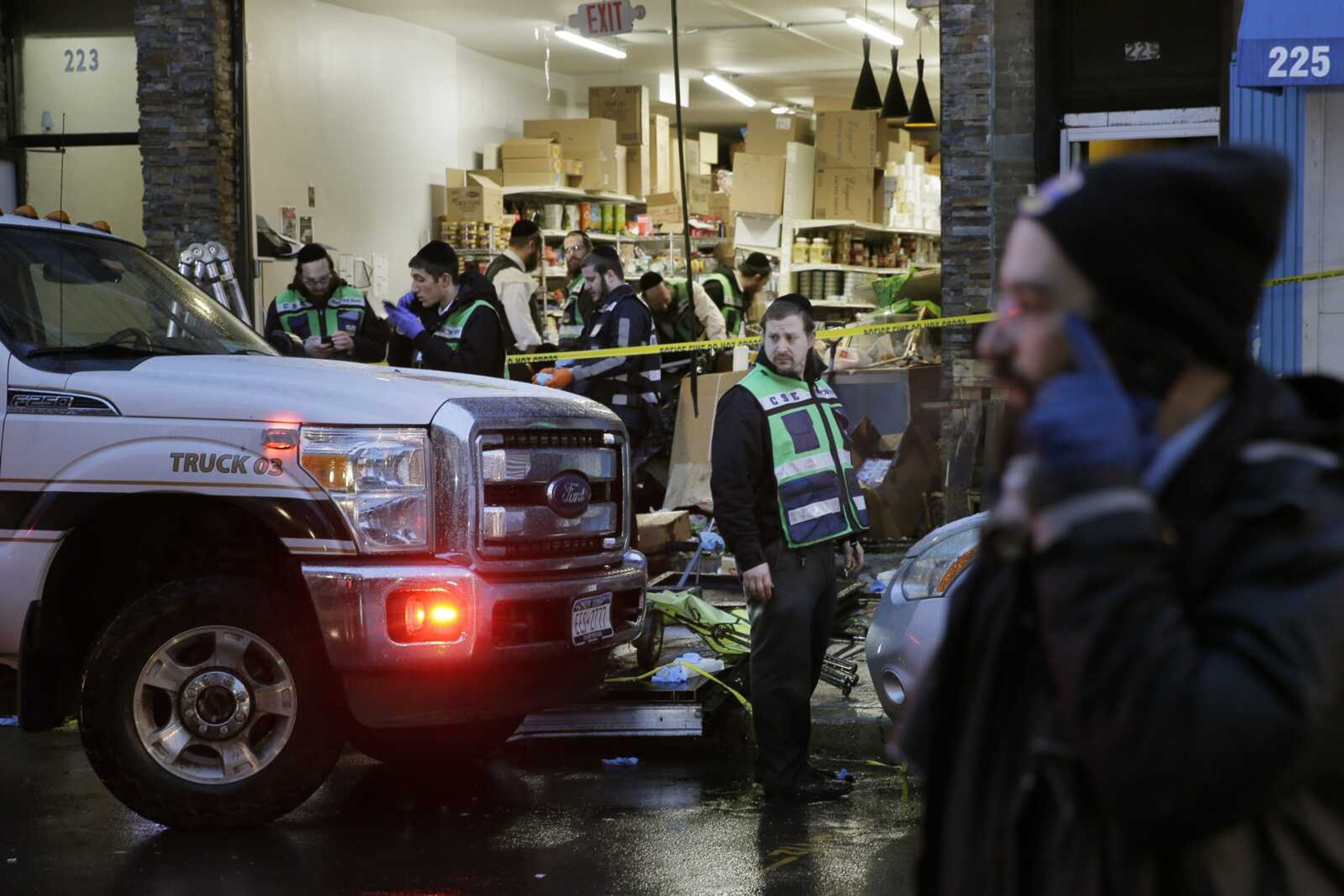 Emergency responders work at a kosher supermarket, the site of a shooting in Jersey City, N.J., Wednesday, Dec. 11, 2019. Jersey City Mayor Steven Fulop said authorities believe gunmen targeted the market during a shooting that killed multiple people Tuesday. (AP Photo/Seth Wenig)