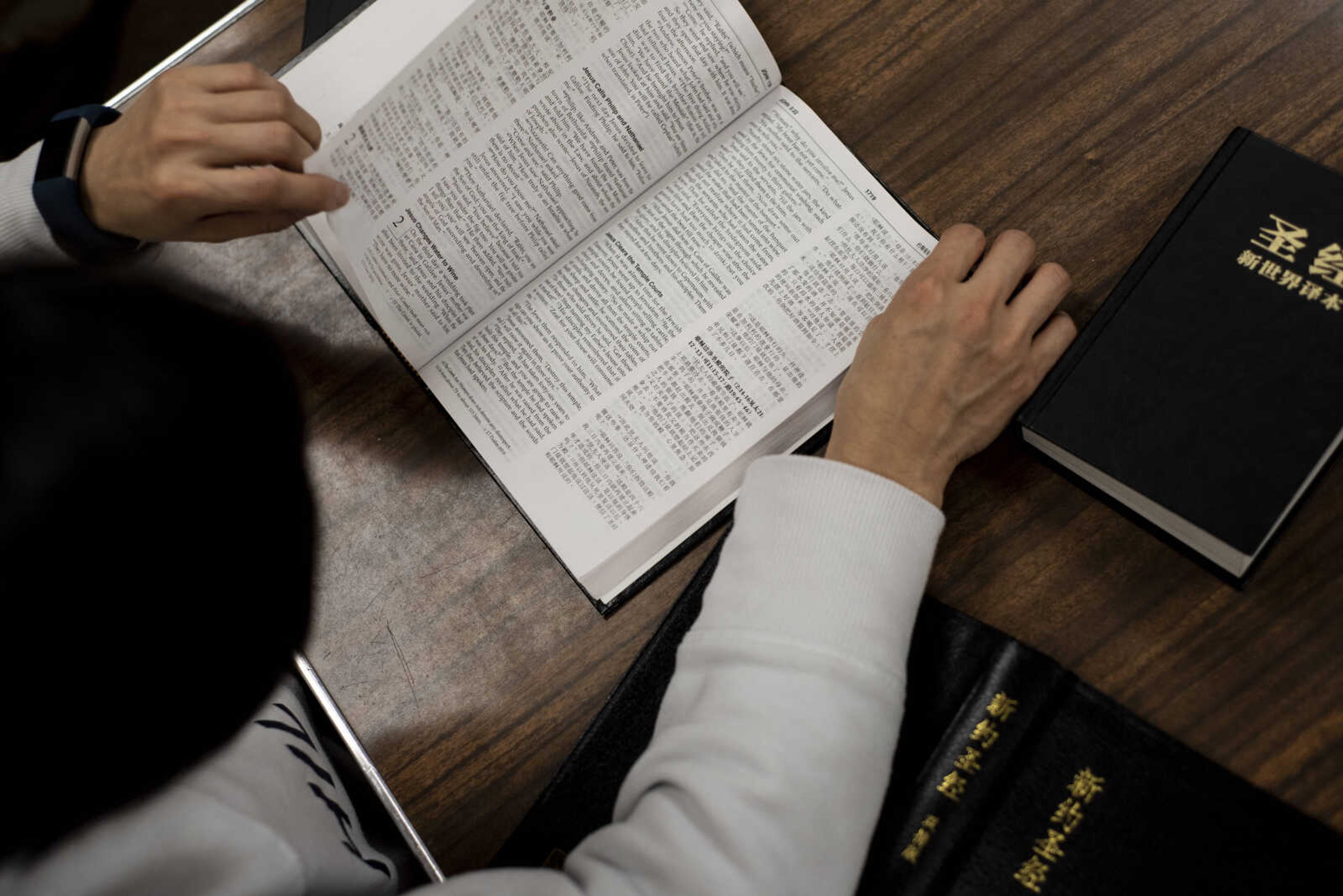 Dr. Chen Wu leafs through her Bible during the weekly Mandarin- and English-spoken Bible study Friday, March 8, 2019, at the Southeast Missouri State University Baptist Student Center in Cape Girardeau.