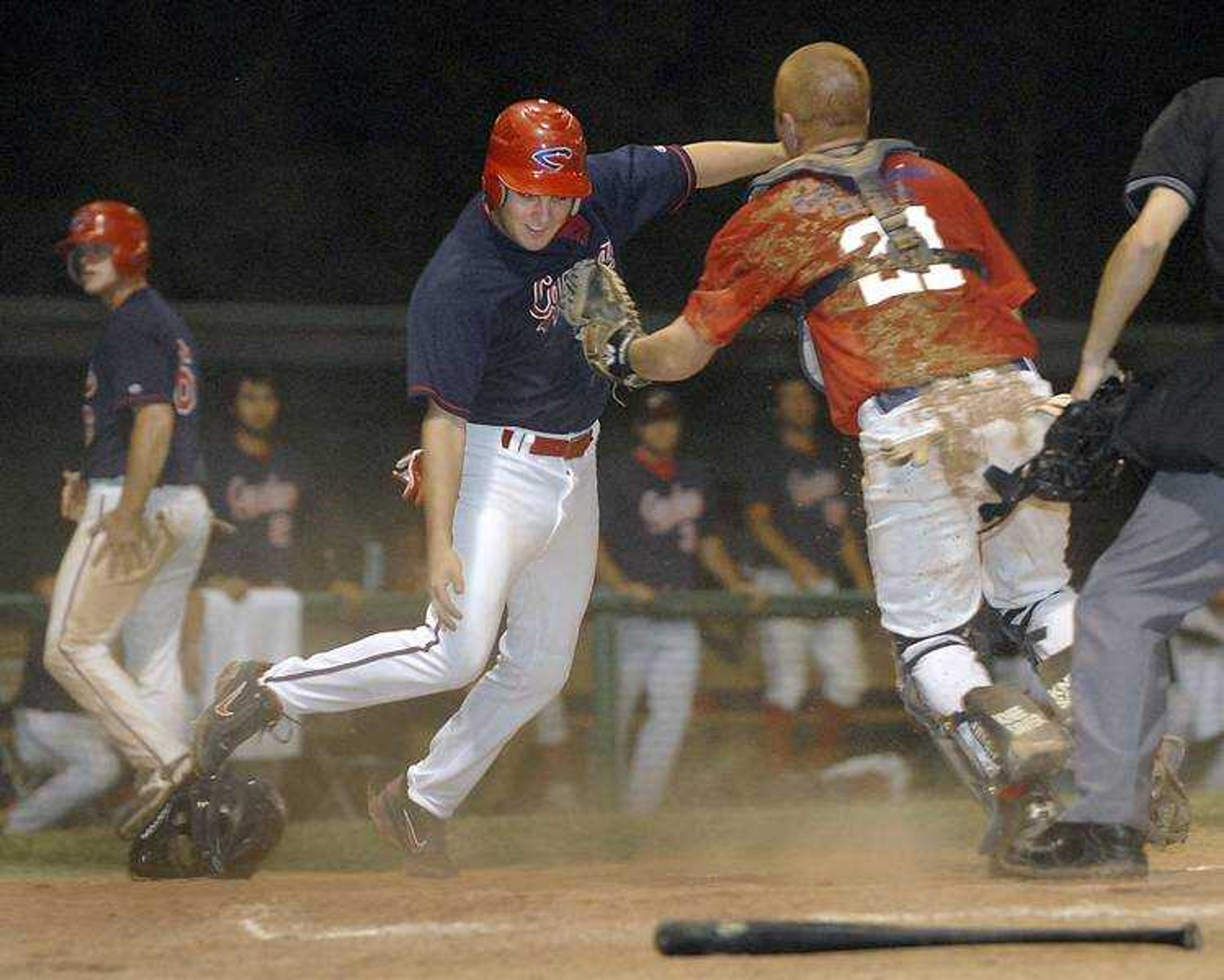 The Capahas' Zach Johnson was tagged out at the plate by Evansville's catcher Steve McNabb just after Kendal Deasonwas called safe (above).