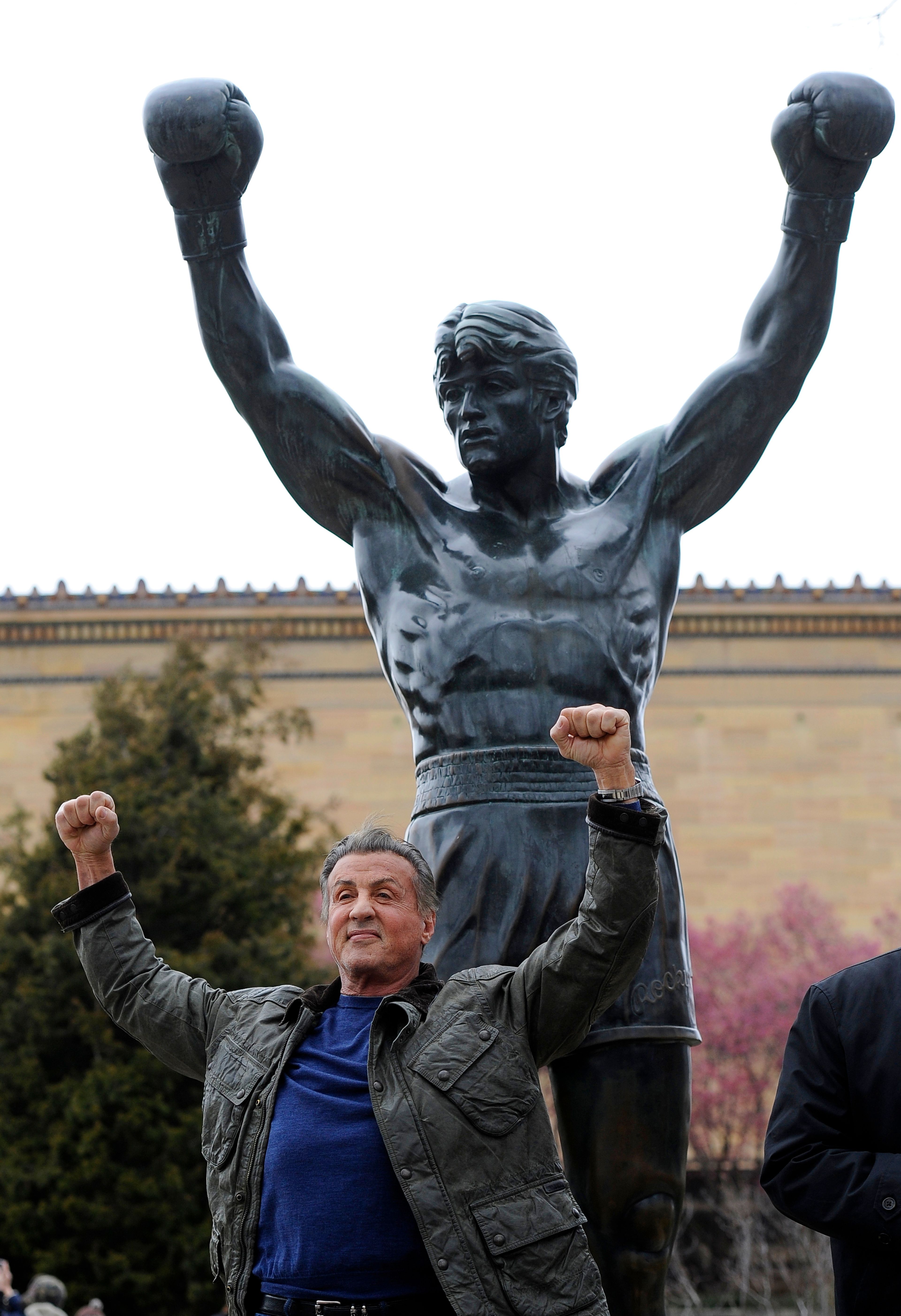 FILE - Sylvester Stallone poses in front of the Rocky statue at the Philadelphia Art Museum at a photo op to promote "Creed II" in Philadelphia on Friday, April 6, 2018. (AP Photo/Michael Perez)