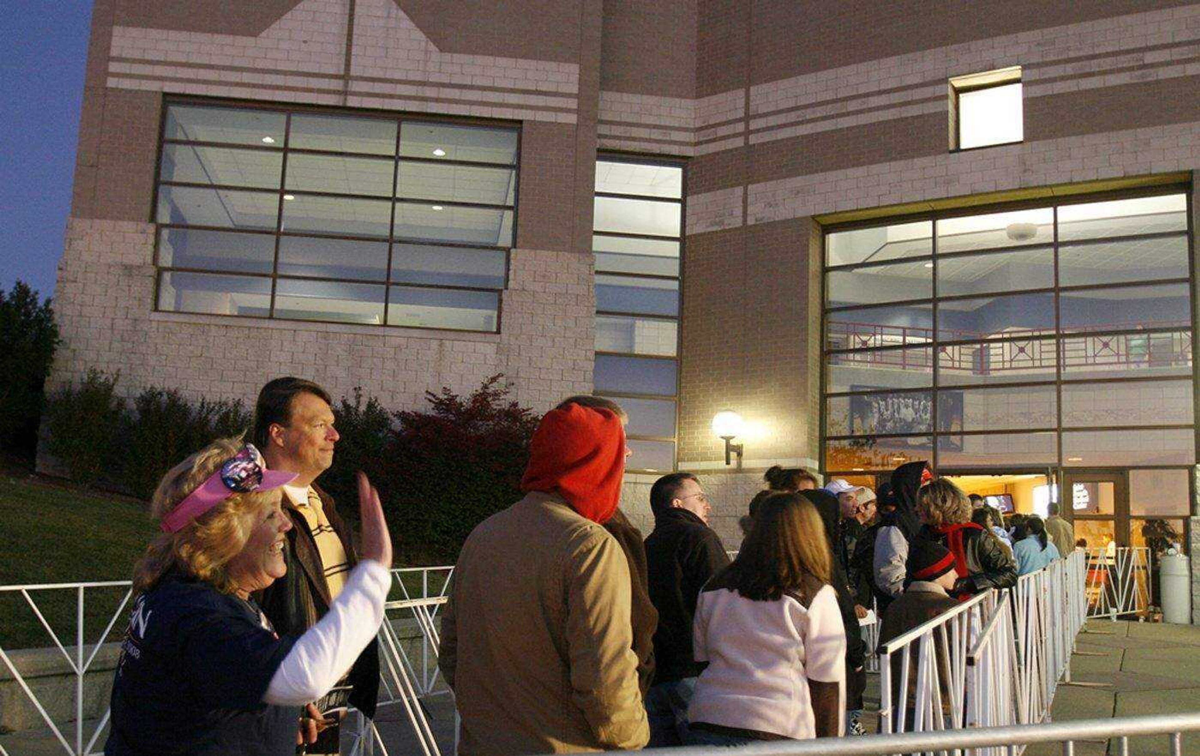 ELIZABETH DODD ~ edodd@semissourian.com
Peggy Ebner, of Jackson, left, waves to a friend while waiting in line at the Show Me Center for the Sarah Palin rally.