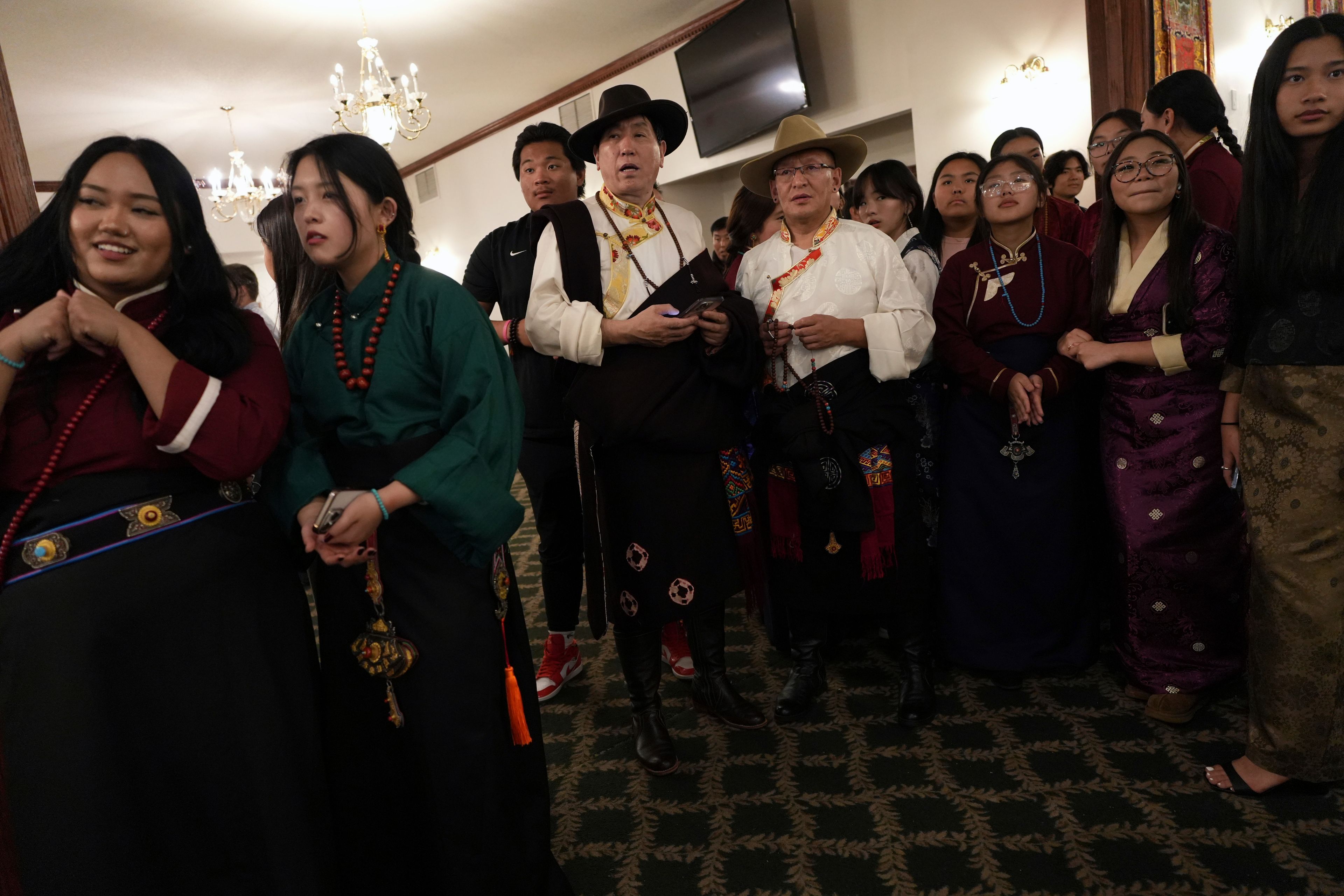 Guests prepare to welcome U.S.-born Buddhist lama, Jalue Dorje, during his 18th birthday and enthronement ceremony at the Tibetan American Foundation of Minnesota in Isanti, Minn., on Saturday, Nov. 9, 2024. (AP Photo/Luis Andres Henao)