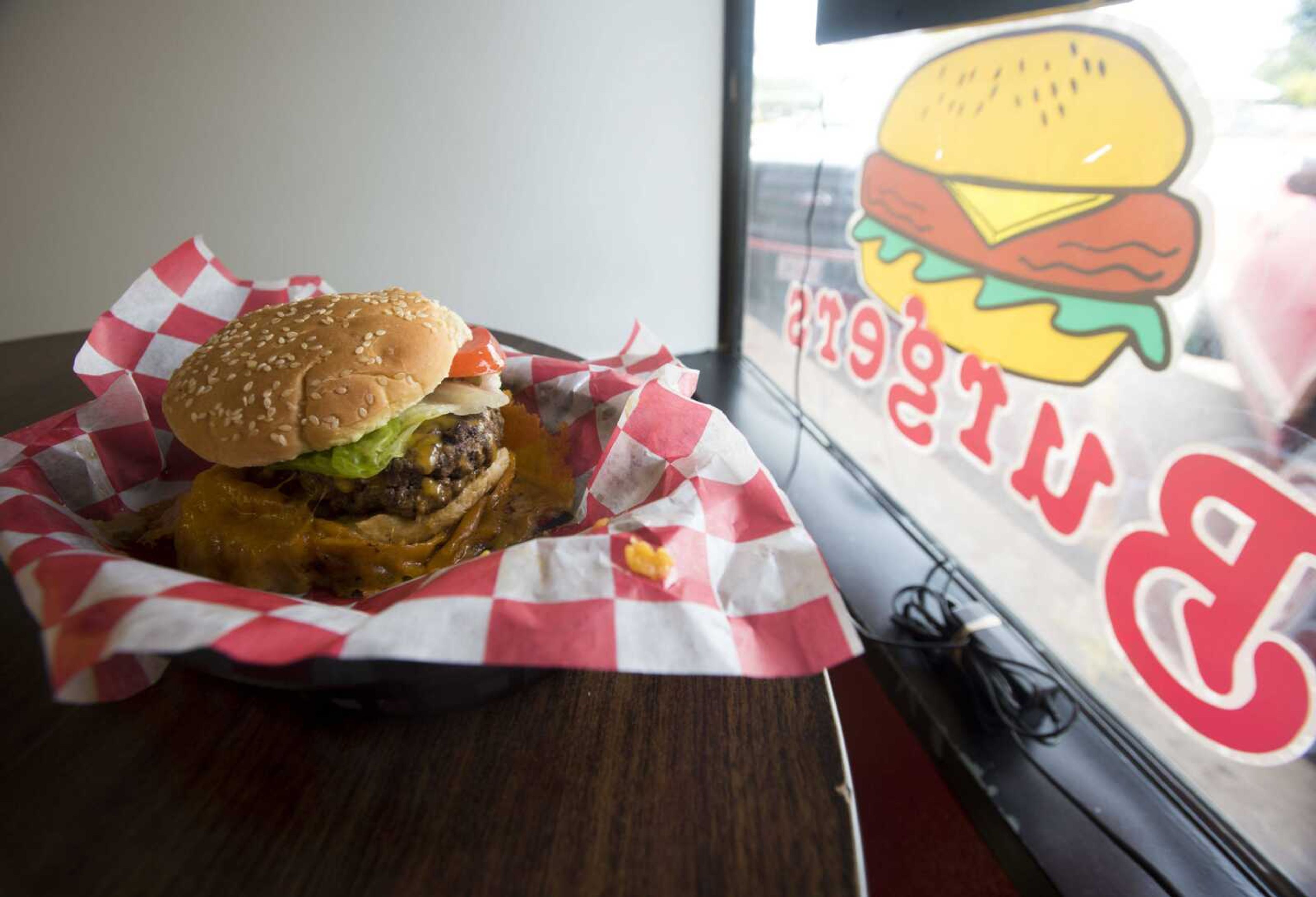 BEN MATTHEWS ~ bmatthews@semissourian.com A fresh cooked Holy Flippin' Cheeseburger sits on a table Sept. 18, 2017 at Kenny's Flippin' Burgers in Chaffee.