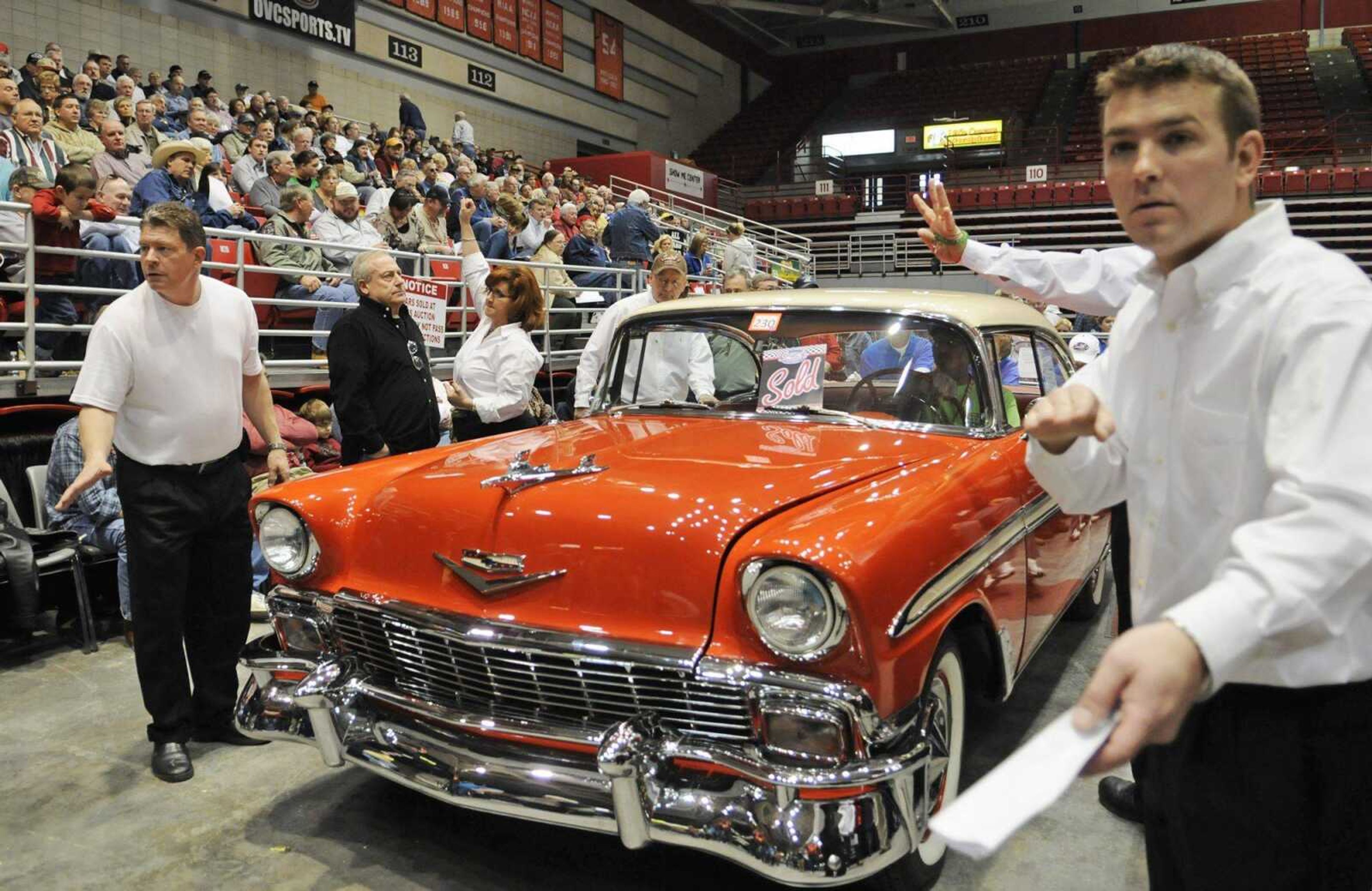 Auctioneers accept bids on a 1956 Chevrolet Bel Air during Smith's Classic Car Auction on Saturday at the Show Me Center. (KRISTIN EBERTS)