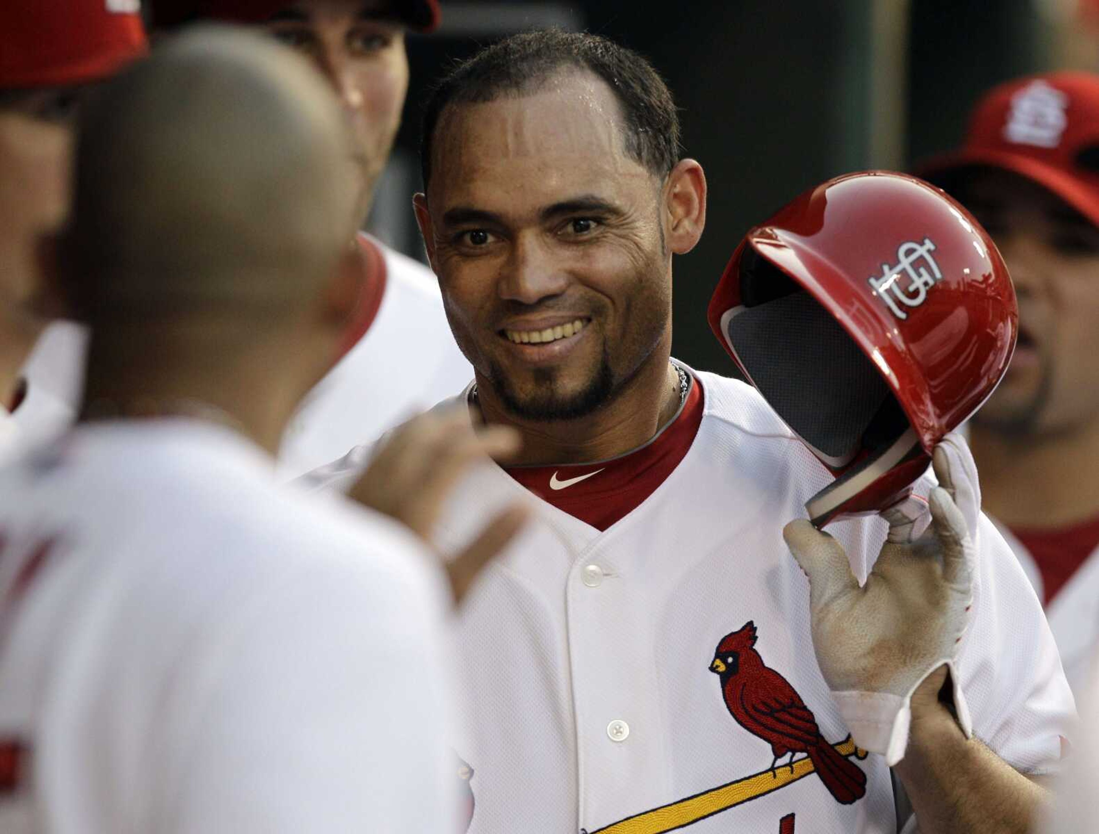 St. Louis Cardinals' Pedro Feliz is congratulated by teammates in the dugout after scoring on a double by Brendan Ryan during the fifth inning of a baseball game against the San Francisco Giants, Saturday, Aug. 21, 2010, in St. Louis. The Cardinals won 5-1. (AP Photo/Jeff Roberson)