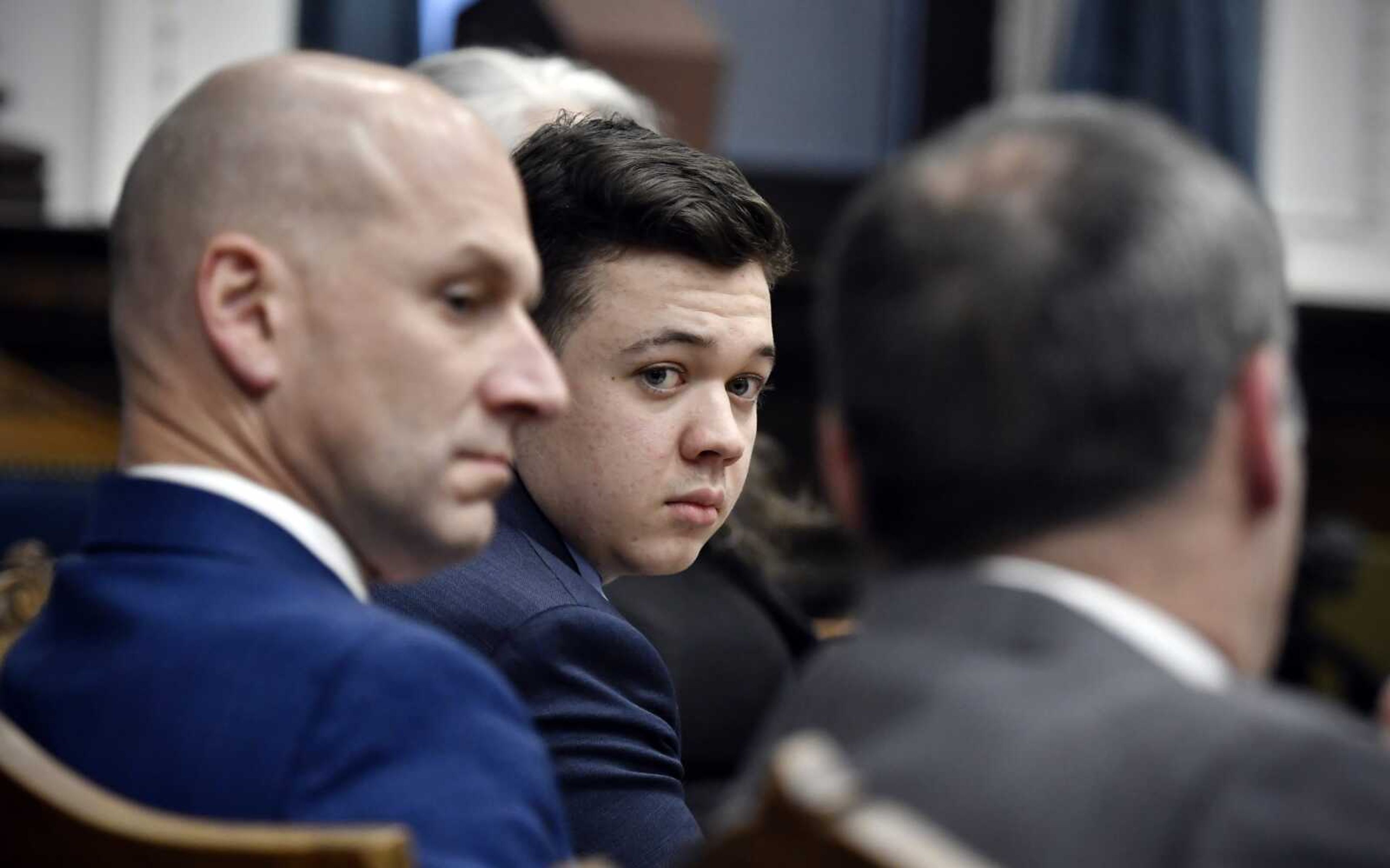 Kyle Rittenhouse, center, looks over to his attorneys Thursday as the jury is dismissed for the day during his trial at the Kenosha County Courthouse in Kenosha, Wisconsin.