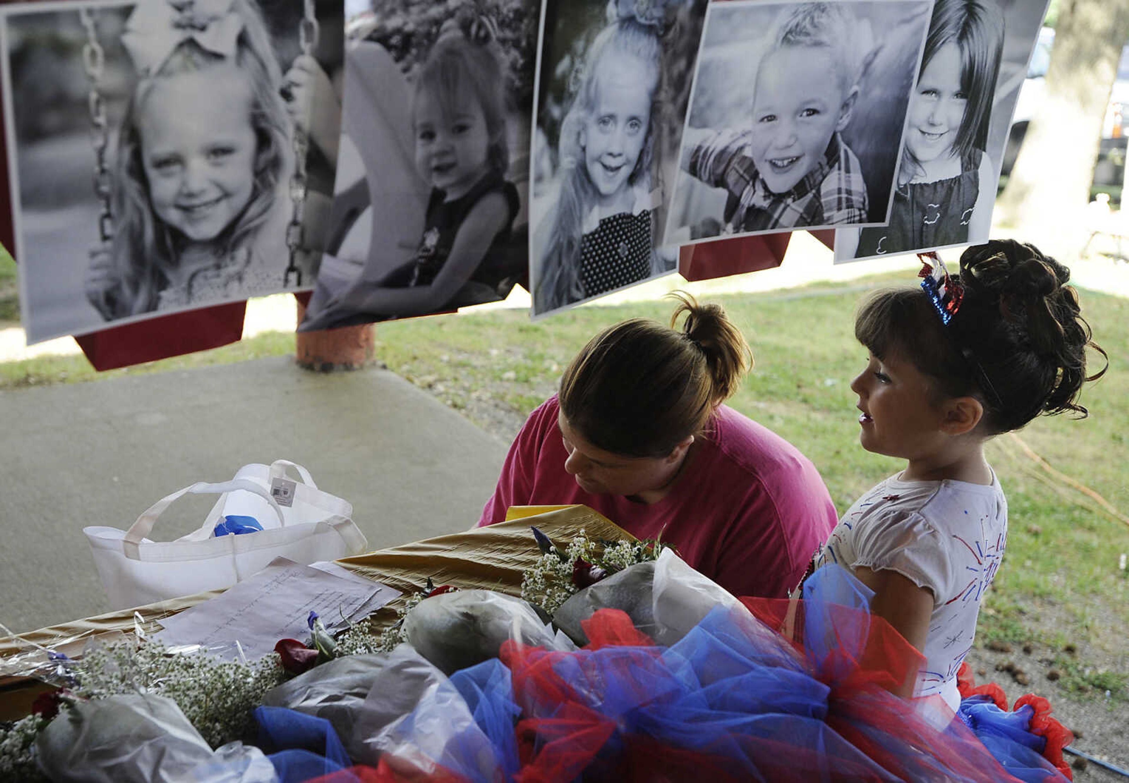 Ashley Gentry signs up her daughter Makenna, 5, for the Summerfest Pageant Show at the 36th annual Scott City Summerfest Friday, June 1, at Scott City Park.