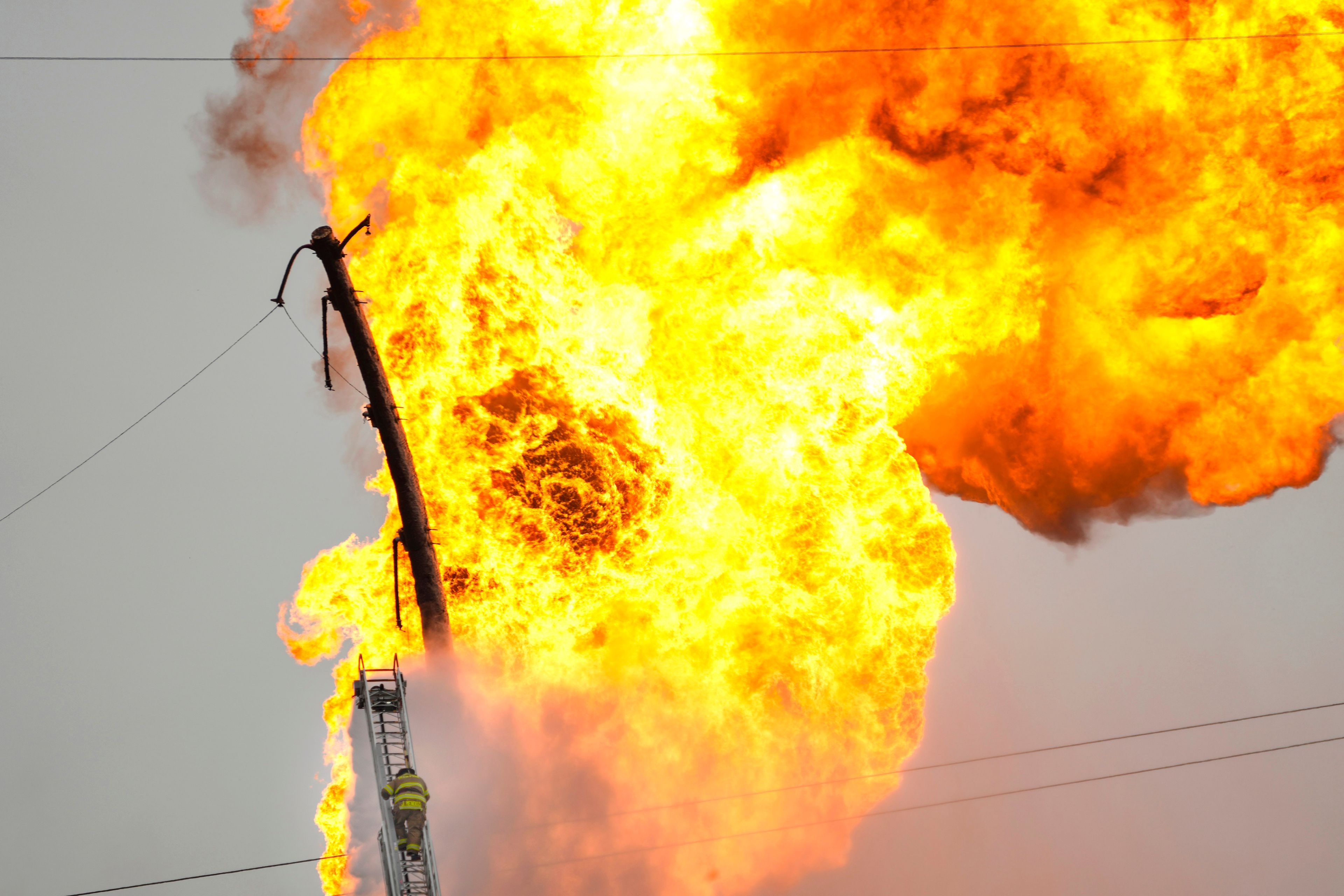 A firefighter directs a line of water around a fire on a pipeline carrying liquified natural gas near Spencer Highway and Summerton on Monday, Sept. 16, 2024, in La Porte, Texas. (Brett Coomer/Houston Chronicle via AP)