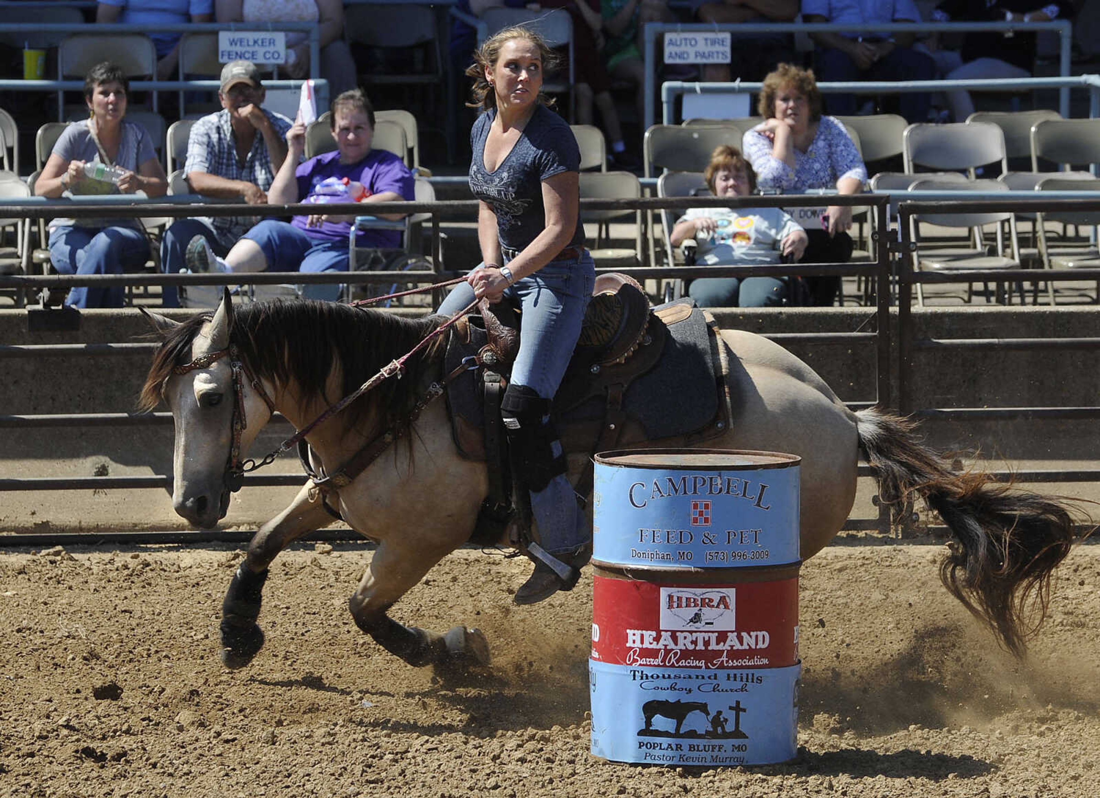 FRED LYNCH ~ flynch@semissourian.com
Becky Maintz rides Jasmine in the Heartland Barrel Racing Extravaganza event Sunday, Sept. 7, 2014 at the SEMO District Fair.