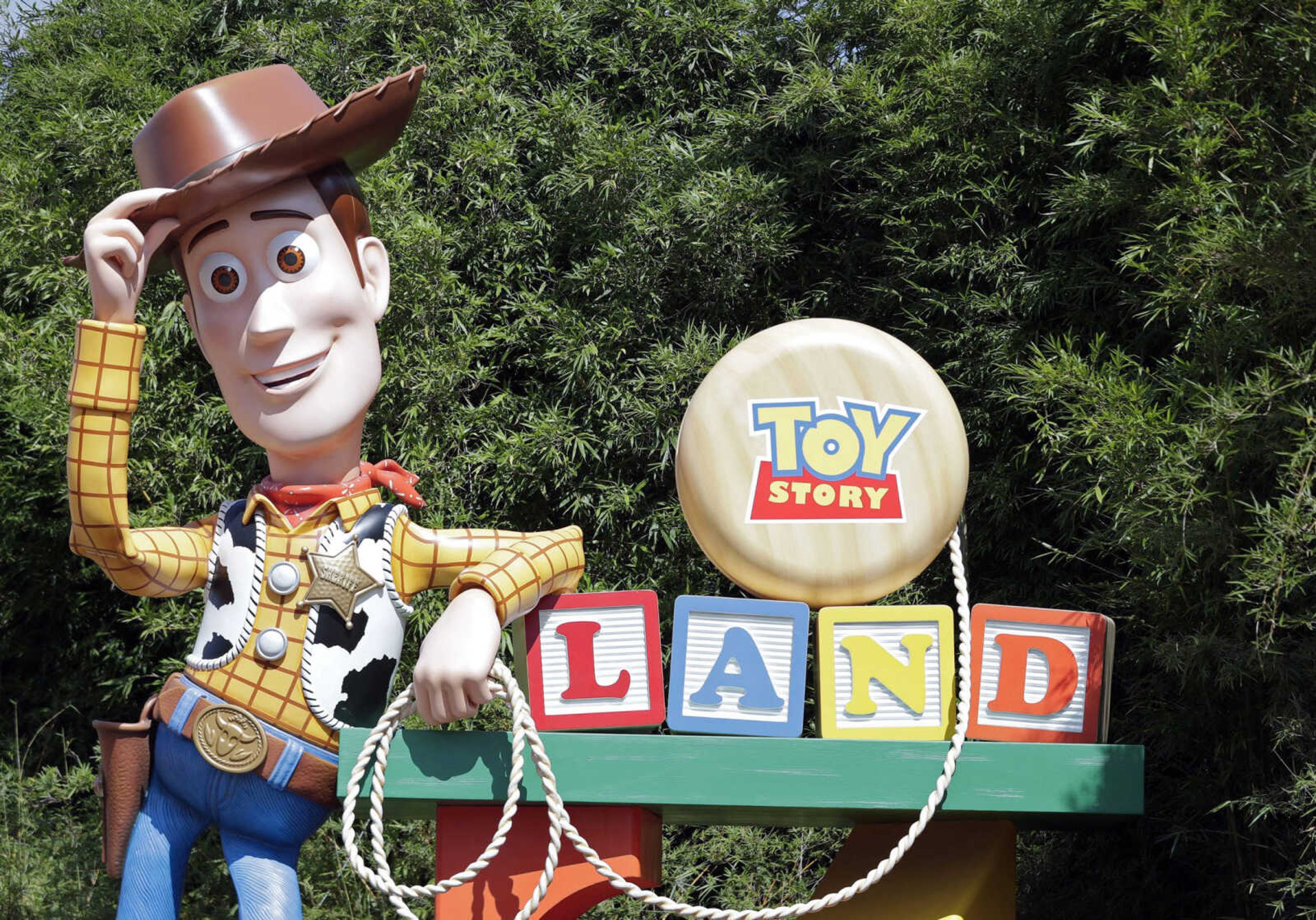 A statue of the character Sheriff Woody greets visitors Saturday at the entrance to Toy Story Land in Disney's Hollywood Studios at Walt Disney World in Lake Buena Vista, Florida.