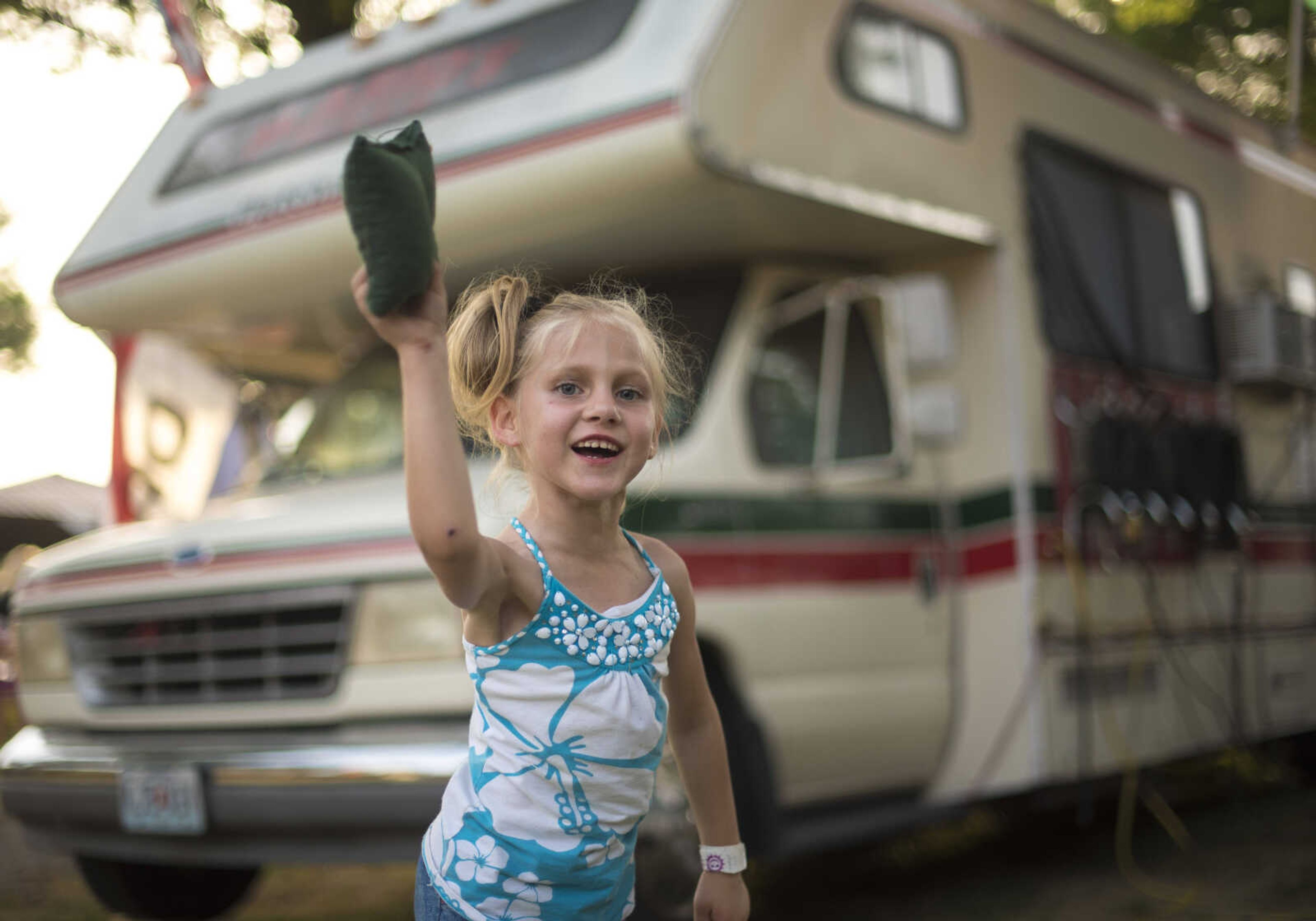 Amber Mayfield, 6, plays cornhole during the 41st annual Mid-Summer Festival Saturday, June 17, 2017 at Scott City Park.