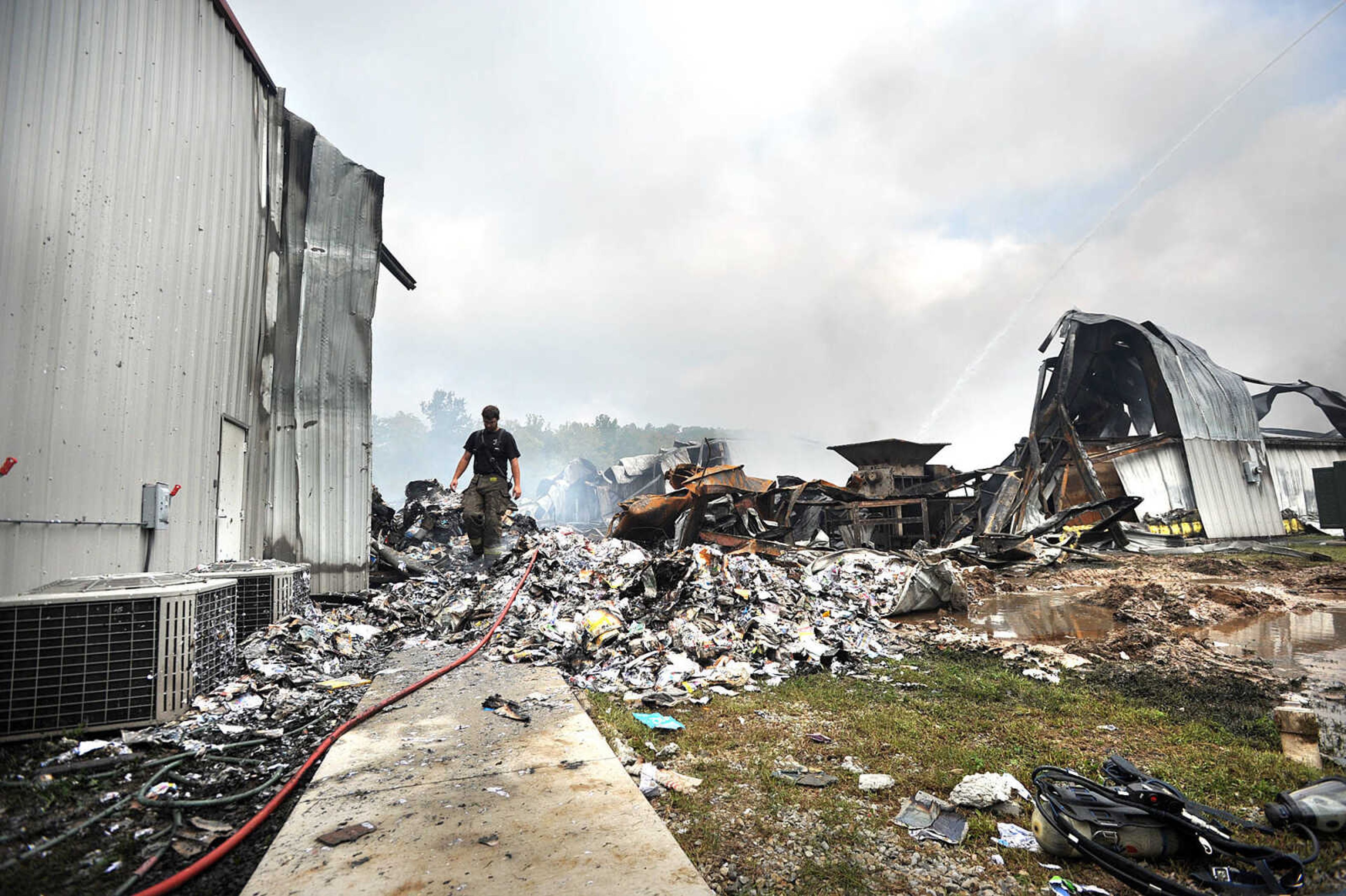 LAURA SIMON ~ lsimon@semissourian.com

David Goehman with the East County Fire Protection District walks through the smoldering ruble of the Missouri Plastics plant Friday morning, Oct. 4, 2013, in Jackson. The approximately 100,00-square-foot recycling plant caught fire around 10 p.m. Thursday. Every fire department in Cape Girardeau County was dispatched to battle the blaze.