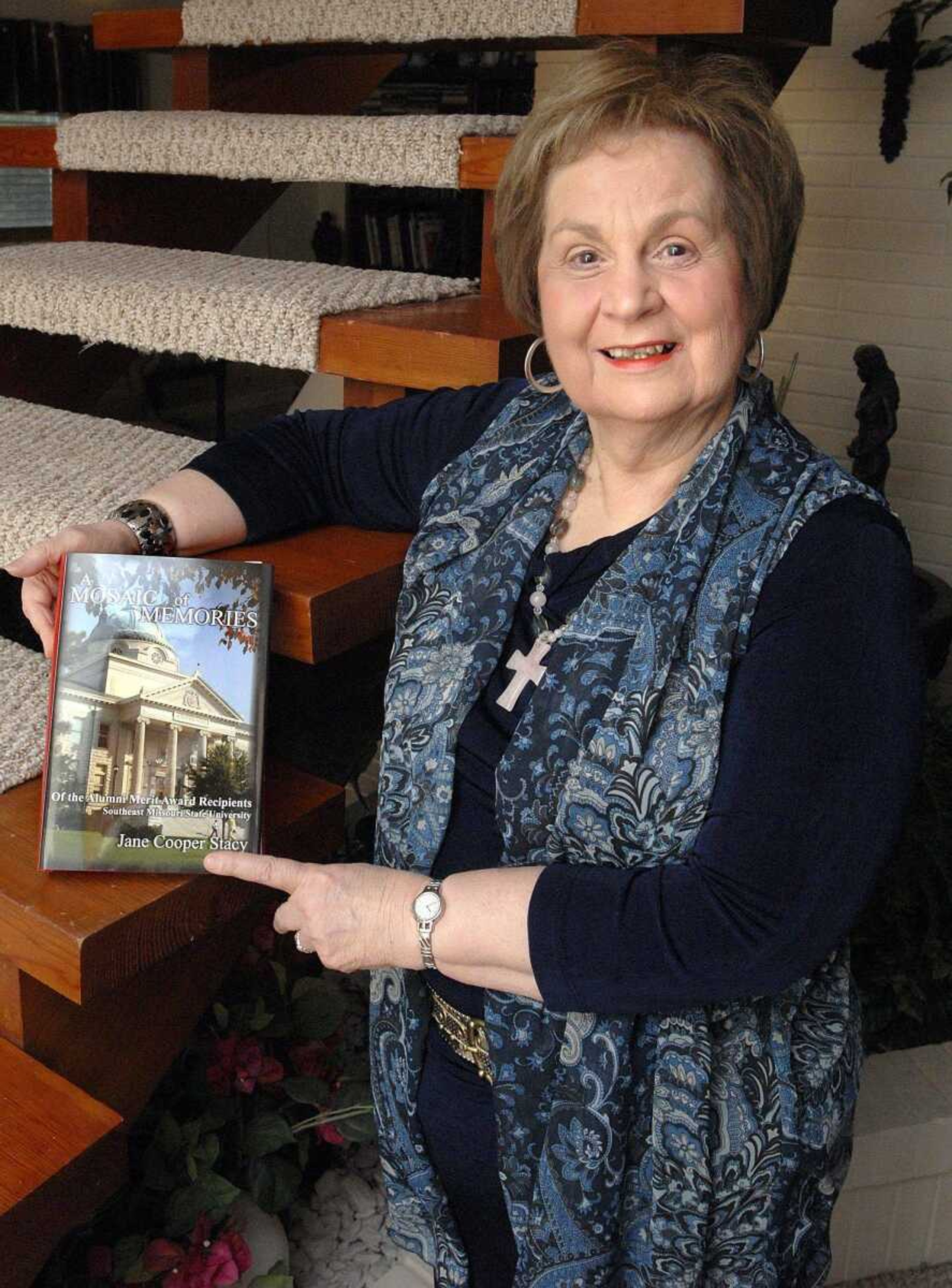 Author Jane Cooper Stacy with her book "A Mosaic of Memories of the Alumni Merit Award Recipients Southeast Missouri State University 1958-2010" at her Cape Girardeau home. (Laura Simon)