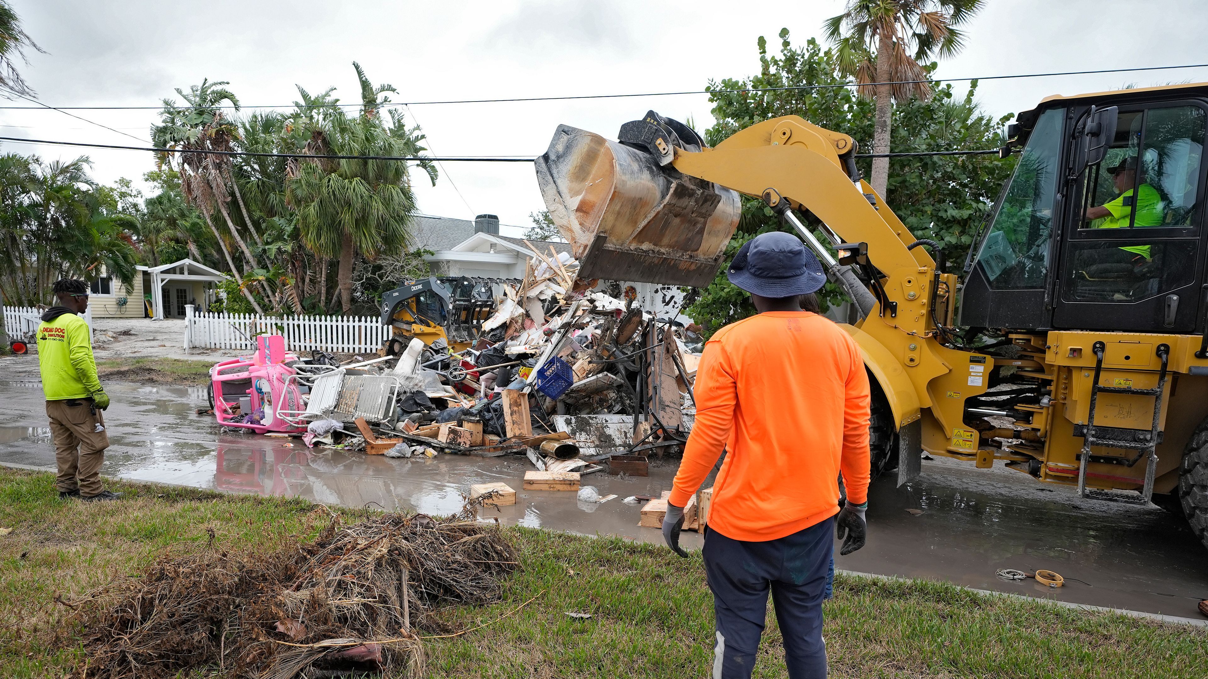 Salvage works remove debris from Hurricane Helene flooding along the Gulf of Mexico Monday, Oct. 7, 2024, in Clearwater Beach, Fla. Crews are working to remove the debris before Hurricane Milton approaches Florida's west coast. (AP Photo/Chris O'Meara)