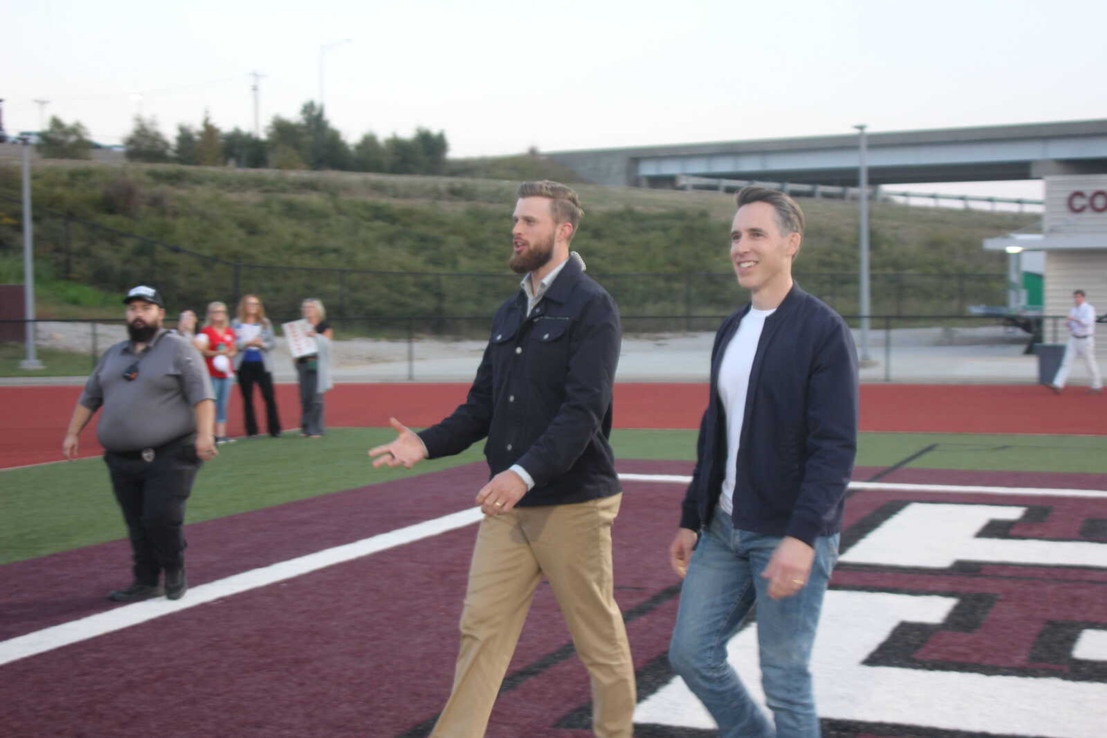 Sen. Josh Hawley, R-Mo., right, and Kansas City Chiefs kicker Harrison Butker walk in the end zone at Mules Stadium on Thursday, Oct. 10, in Poplar Bluff.