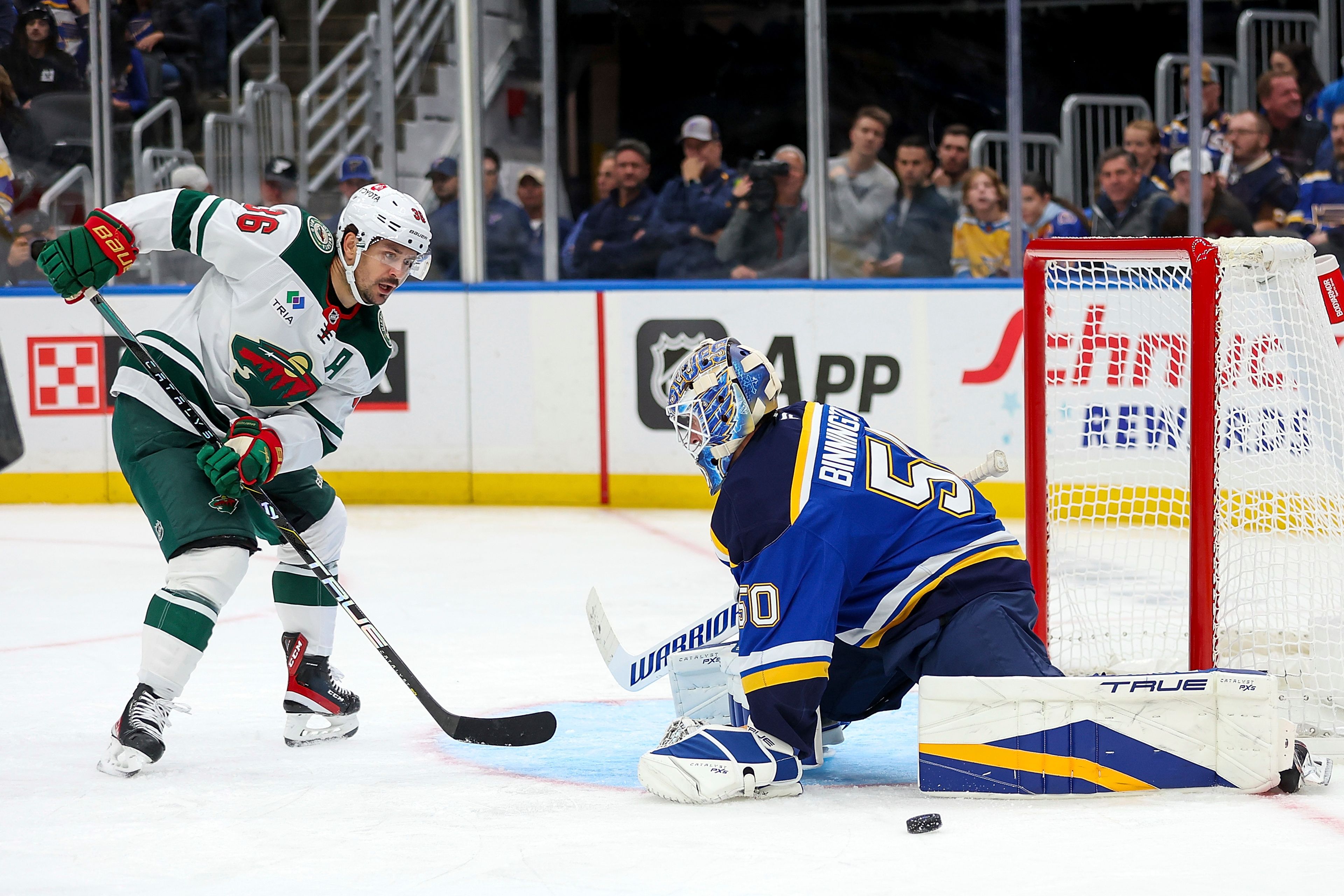 St. Louis Blues goaltender Jordan Binnington (50) defends against Mats Zuccarello during the third period of an NHL hockey game Tuesday, October 15, 2024, in St. Louis. (AP Photo/Scott Kane)