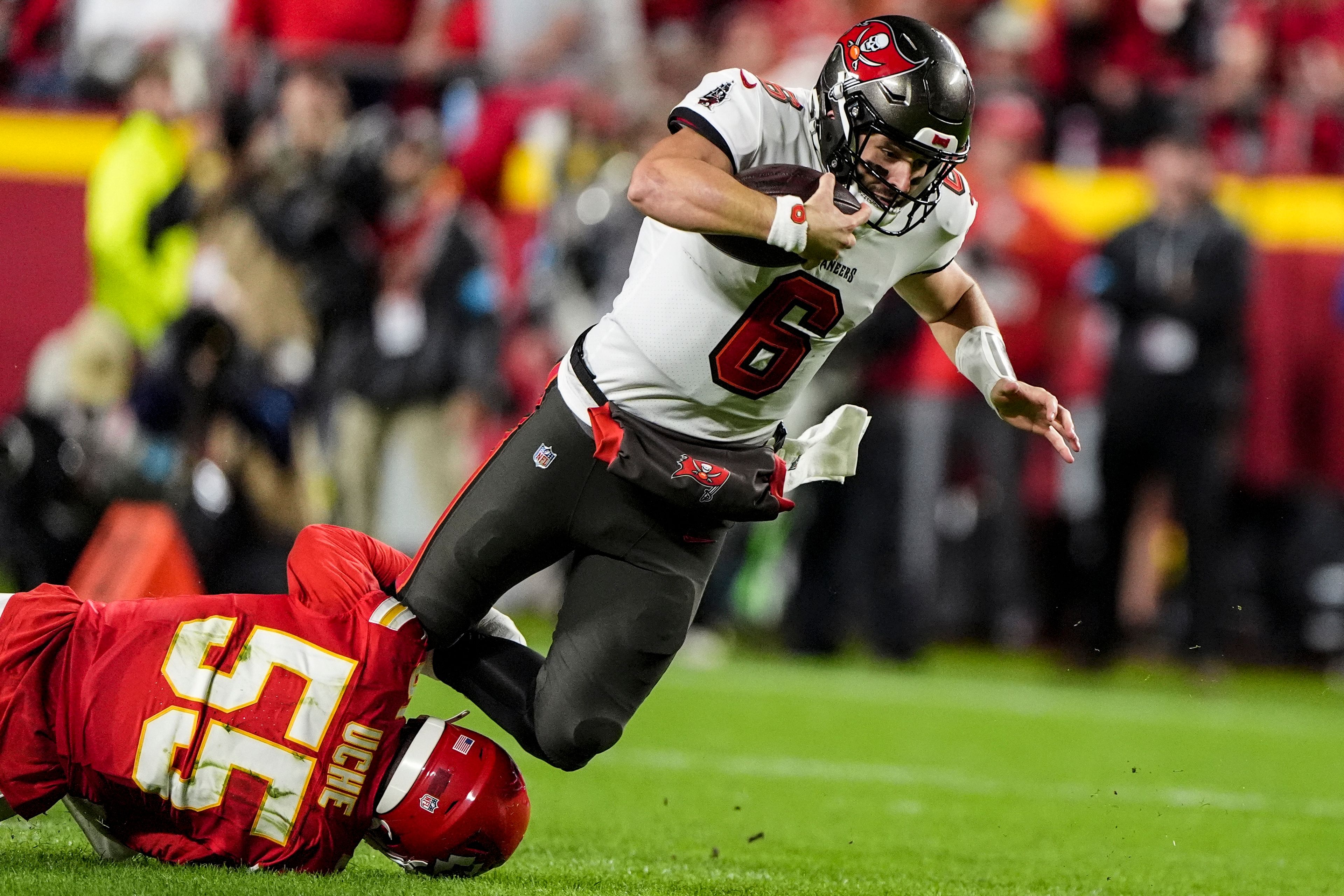 Kansas City Chiefs linebacker Joshua Uche (55) tackles Tampa Bay Buccaneers quarterback Baker Mayfield (6) during the first half of an NFL football game, Monday, Nov. 4, 2024, in Kansas City, Mo. (AP Photo/Charlie Riedel)