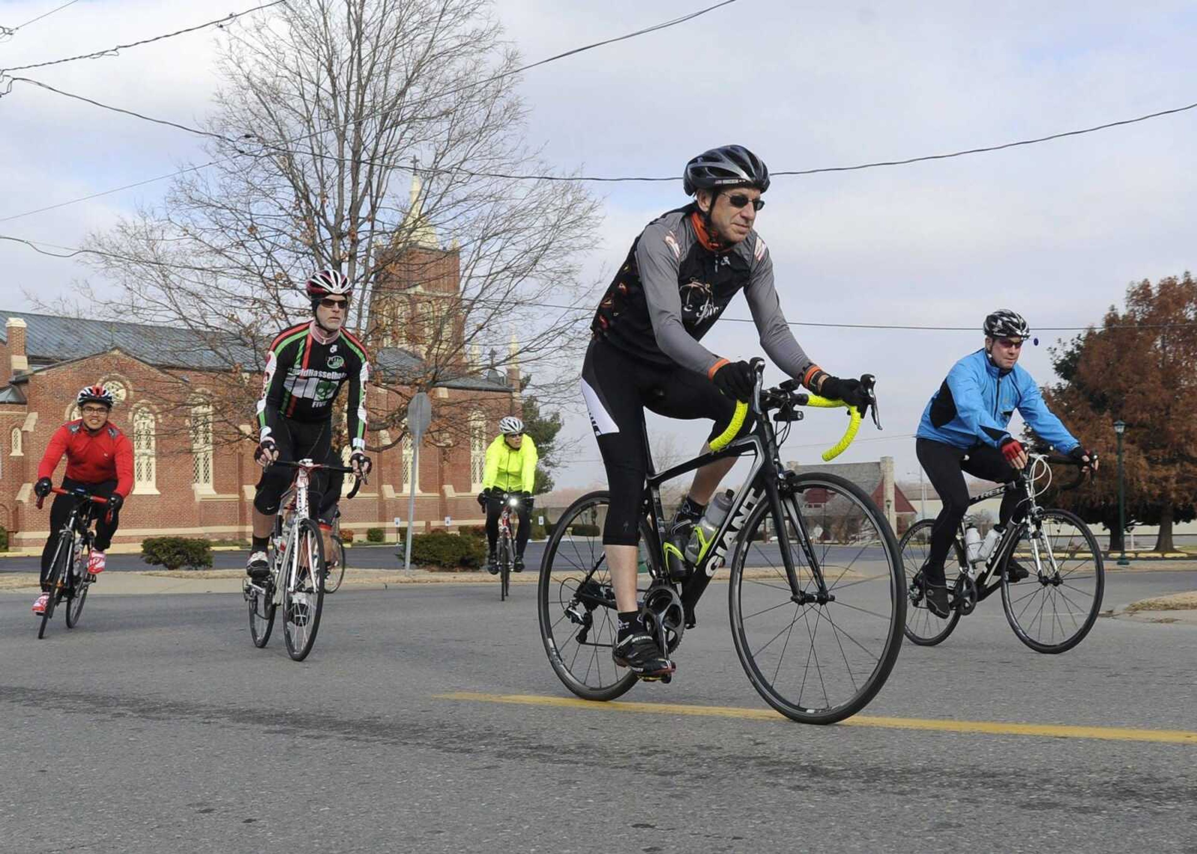 Don Hinkebein, front, and Steve Gerard, right, lead members of the Velo Girardeau bicycle club onto Spanish Street as they begin a ride to Illinois on Sunday in Cape Girardeau. Other members include J.J. Lee, left, Jim Summers and Kurt Hougland. (Fred Lynch)