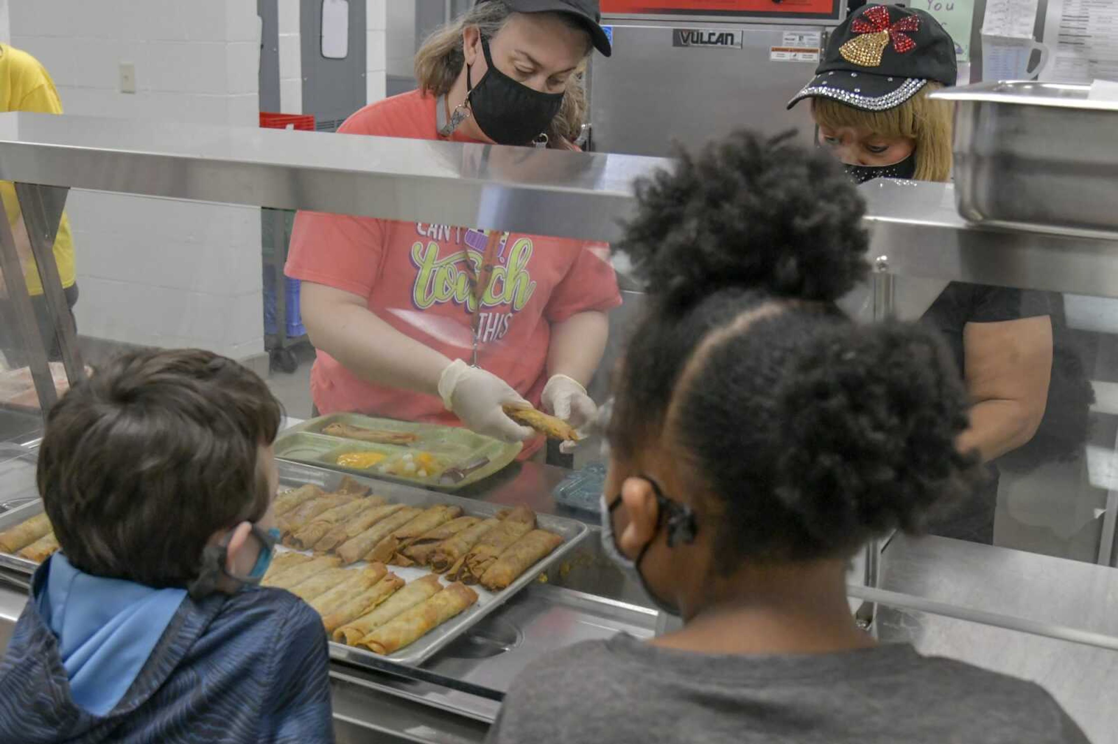 Cafeteria staff prepare lunch plates with crispitos at Alma Schrader Elementary School on March 25 in Cape Girardeau.