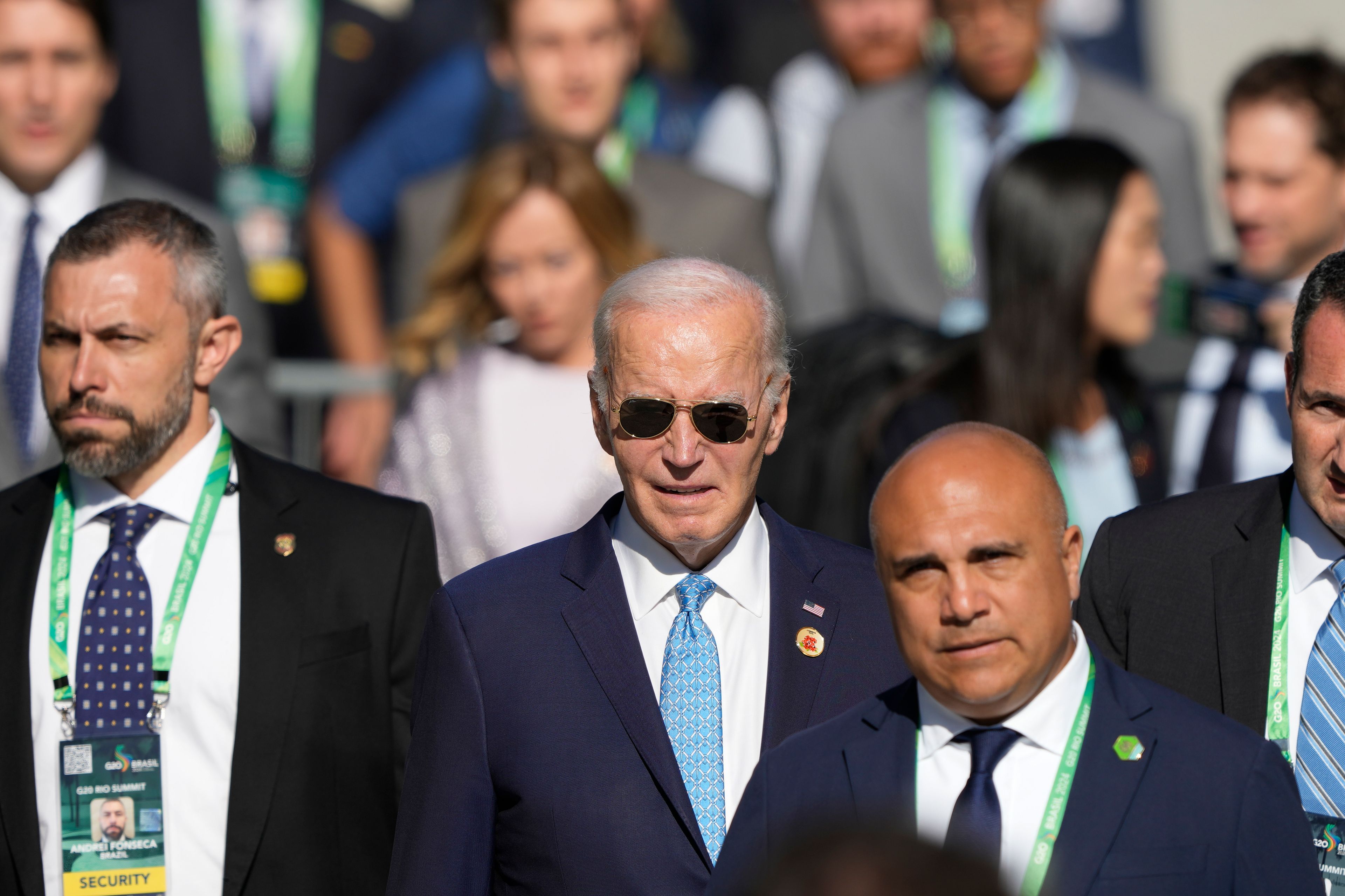 U.S. President Joe Biden arrives late for the group photo during the G20 Summit in Rio de Janeiro, Monday, Nov. 18, 2024. (AP Photo/Eraldo Peres)