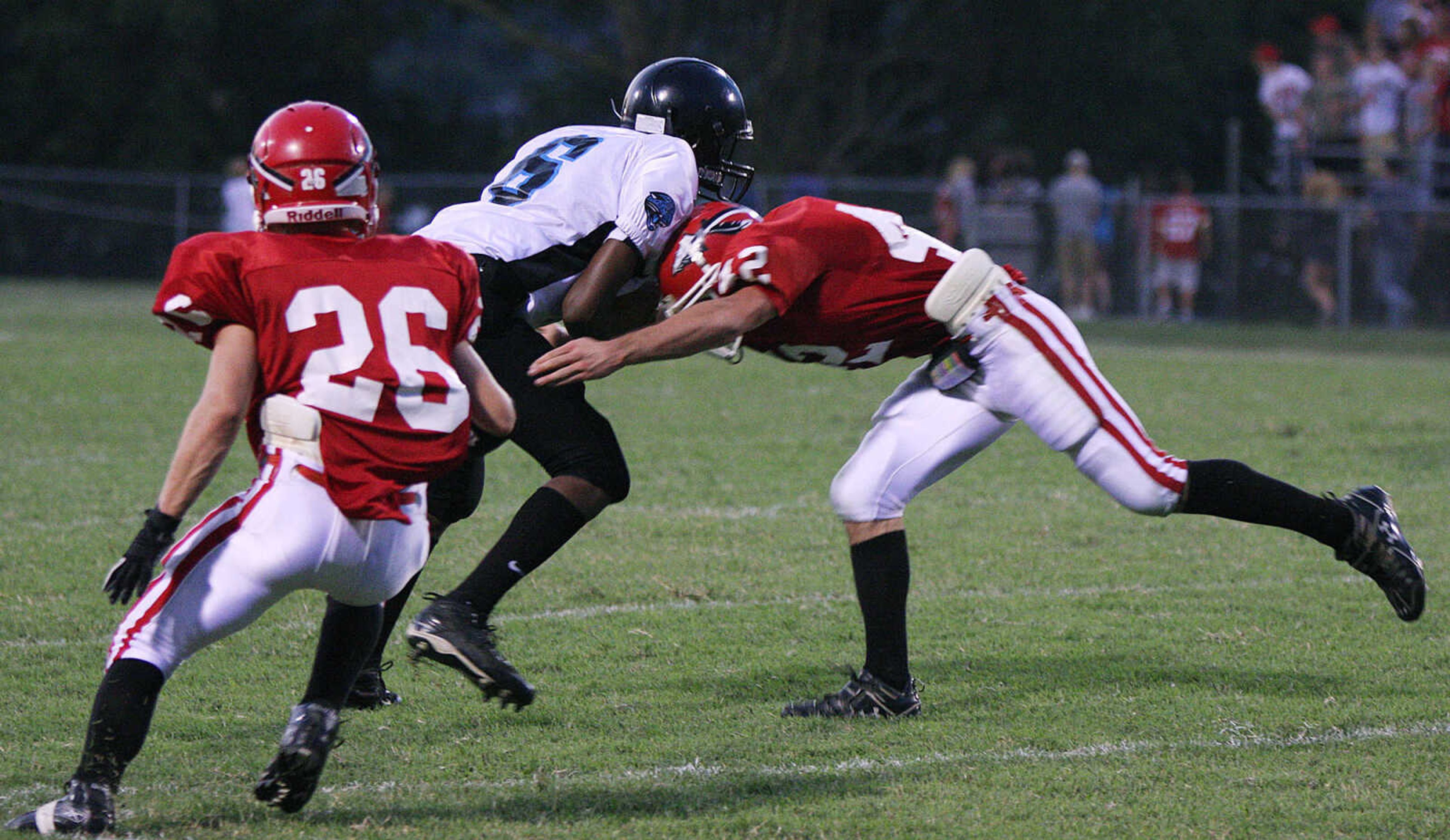 Jackson's Ryan Marble, right, sticks Gateway Tech's Leland Davis, center, as Stetson Proffer, left, comes to help.