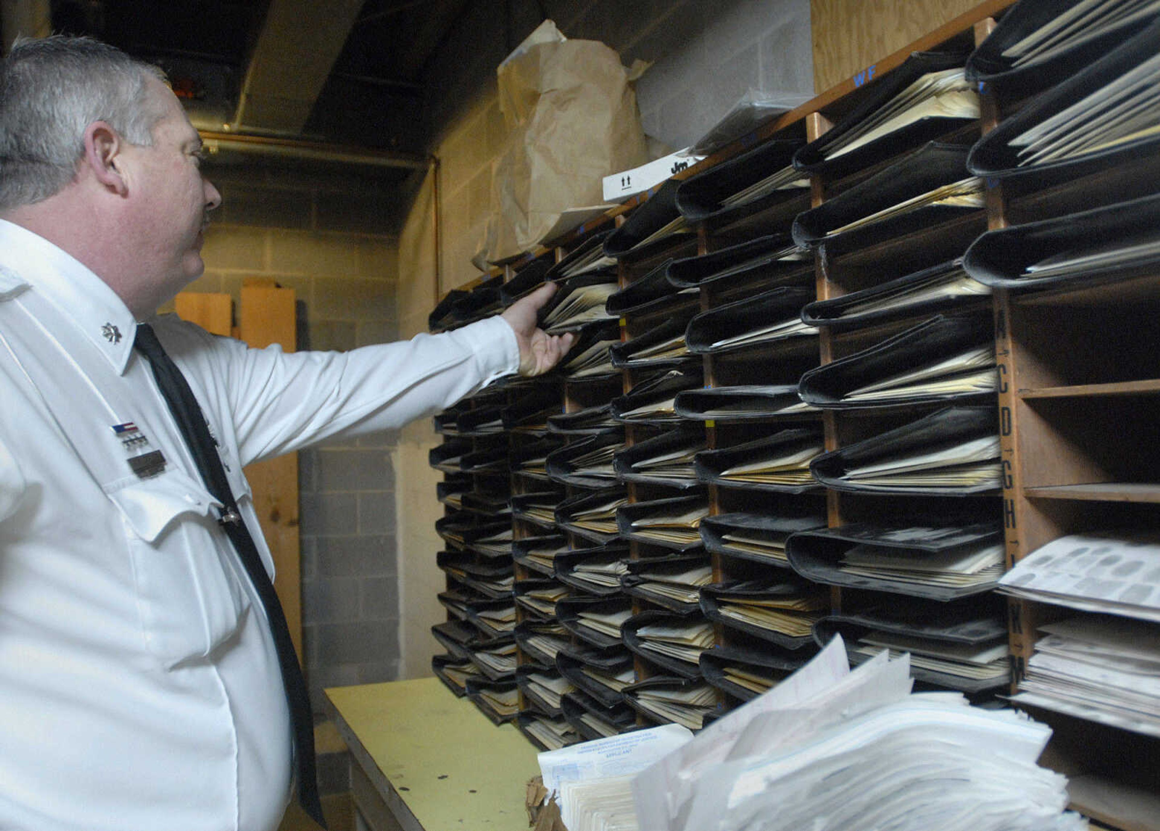 LAURA SIMON ~ lsimon@semissourian.com
Assistant Chief Roger Fields shows the stacks of old mug shots from the 1980's that are stored in the basement of the Cape Girardeau Police Department Friday, February 10, 2012.